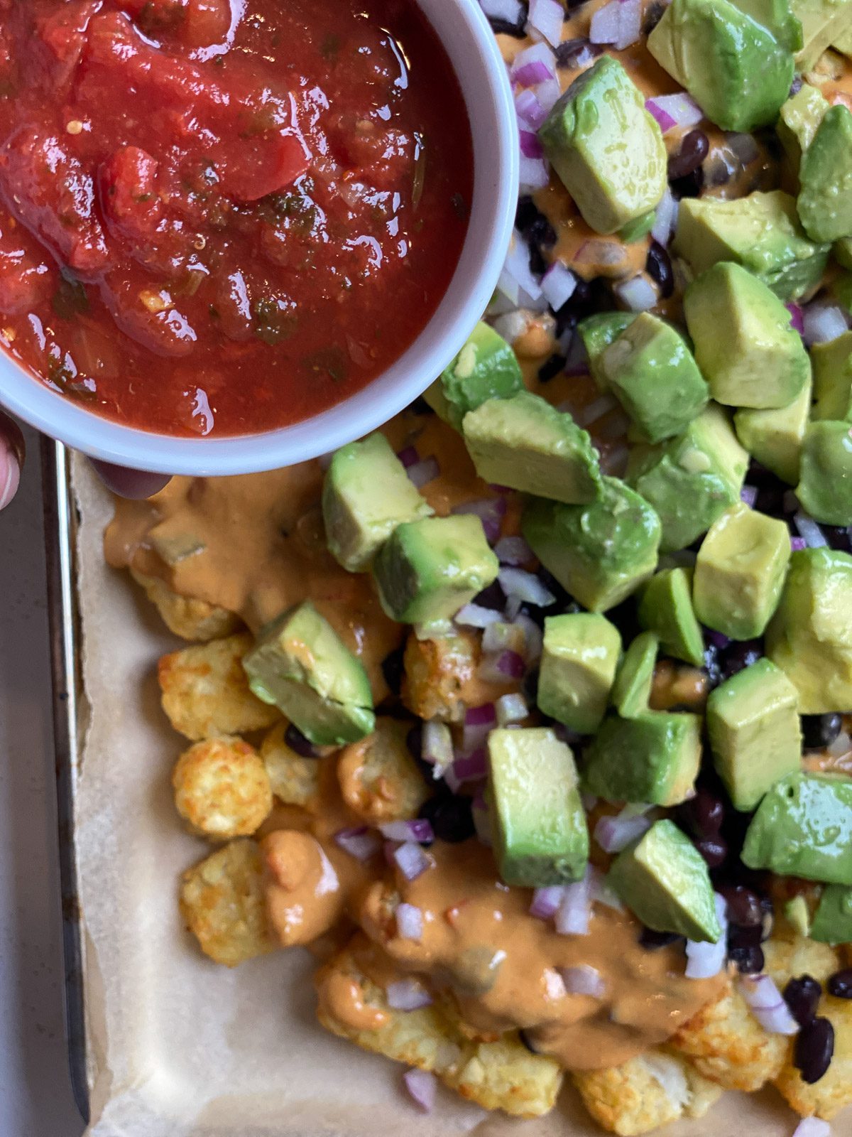 process of adding salsa to tochos