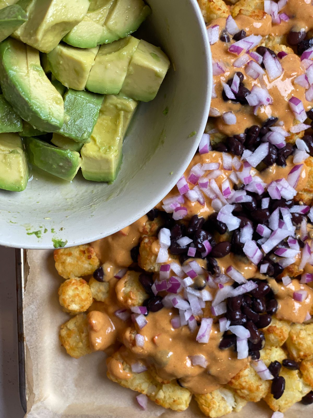 process of adding avocado to totchos