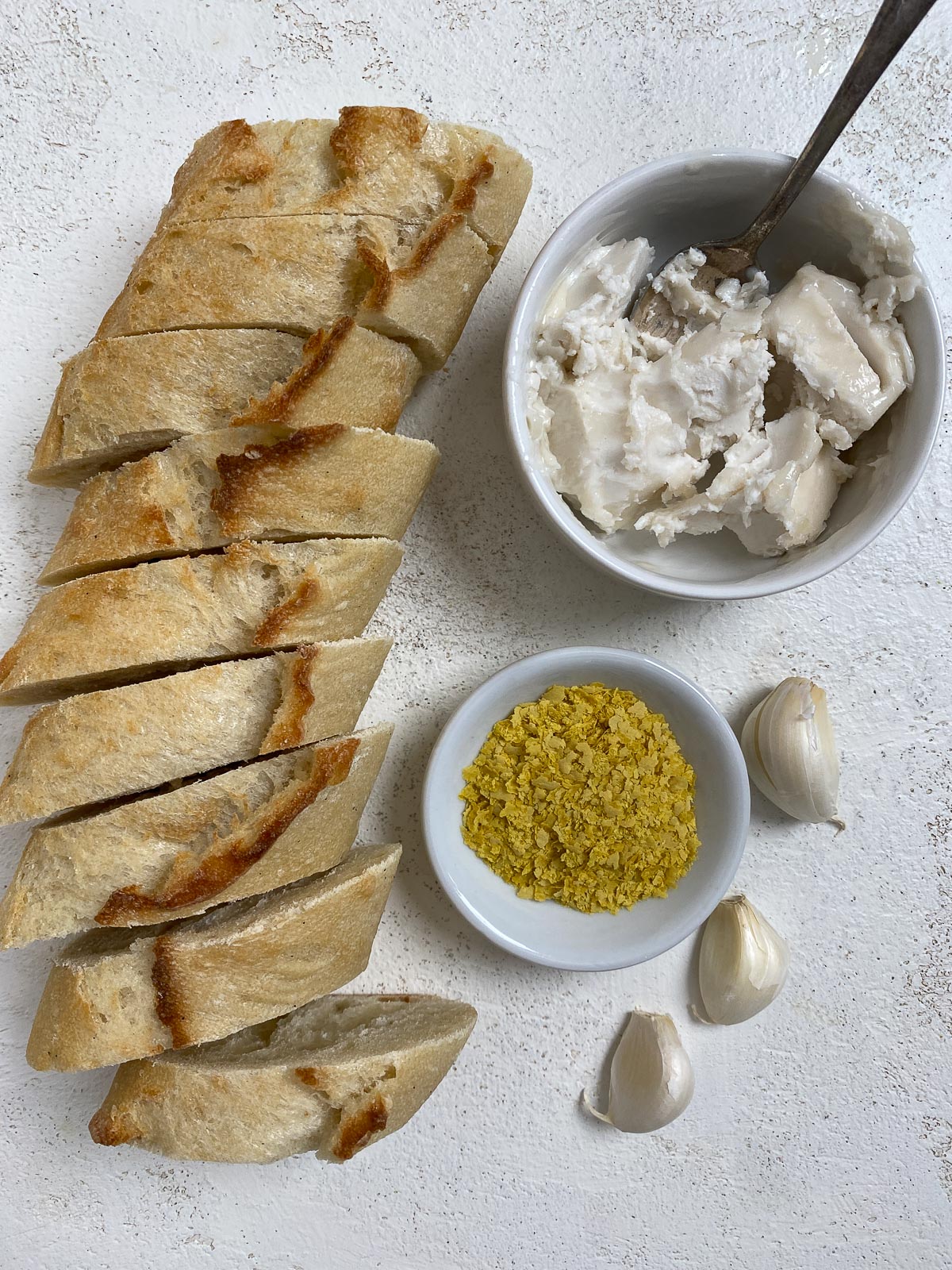 ingredients for air fryer garlic bread on a white surface