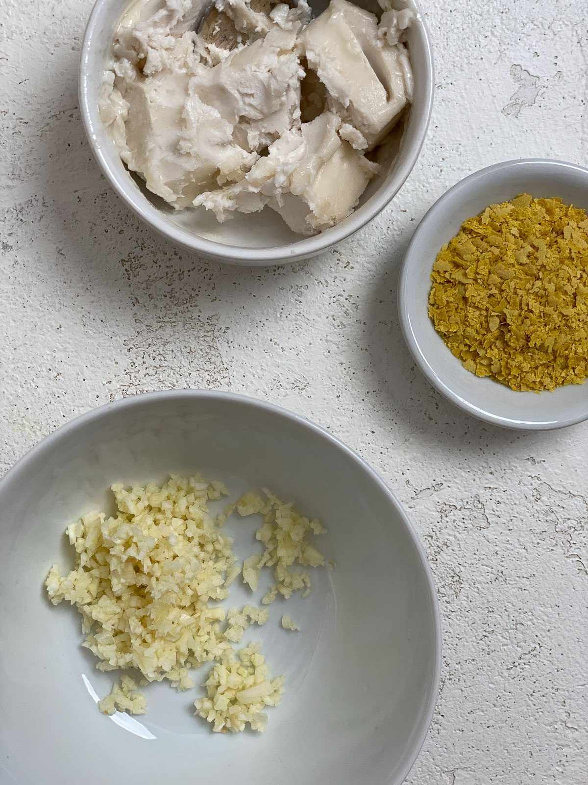 ingredients for air fryer garlic bread on a white surface