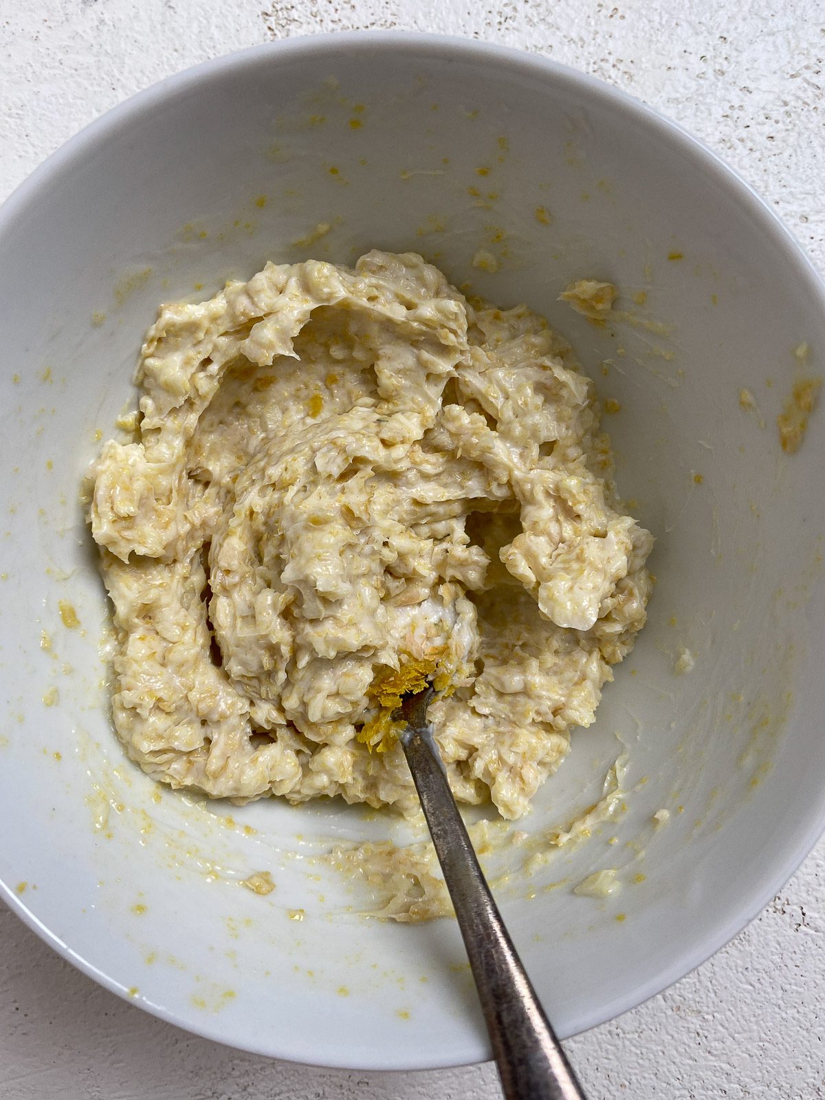 process of mixing ingredients for Vegan Air Fryer Garlic Bread in a small white bowl