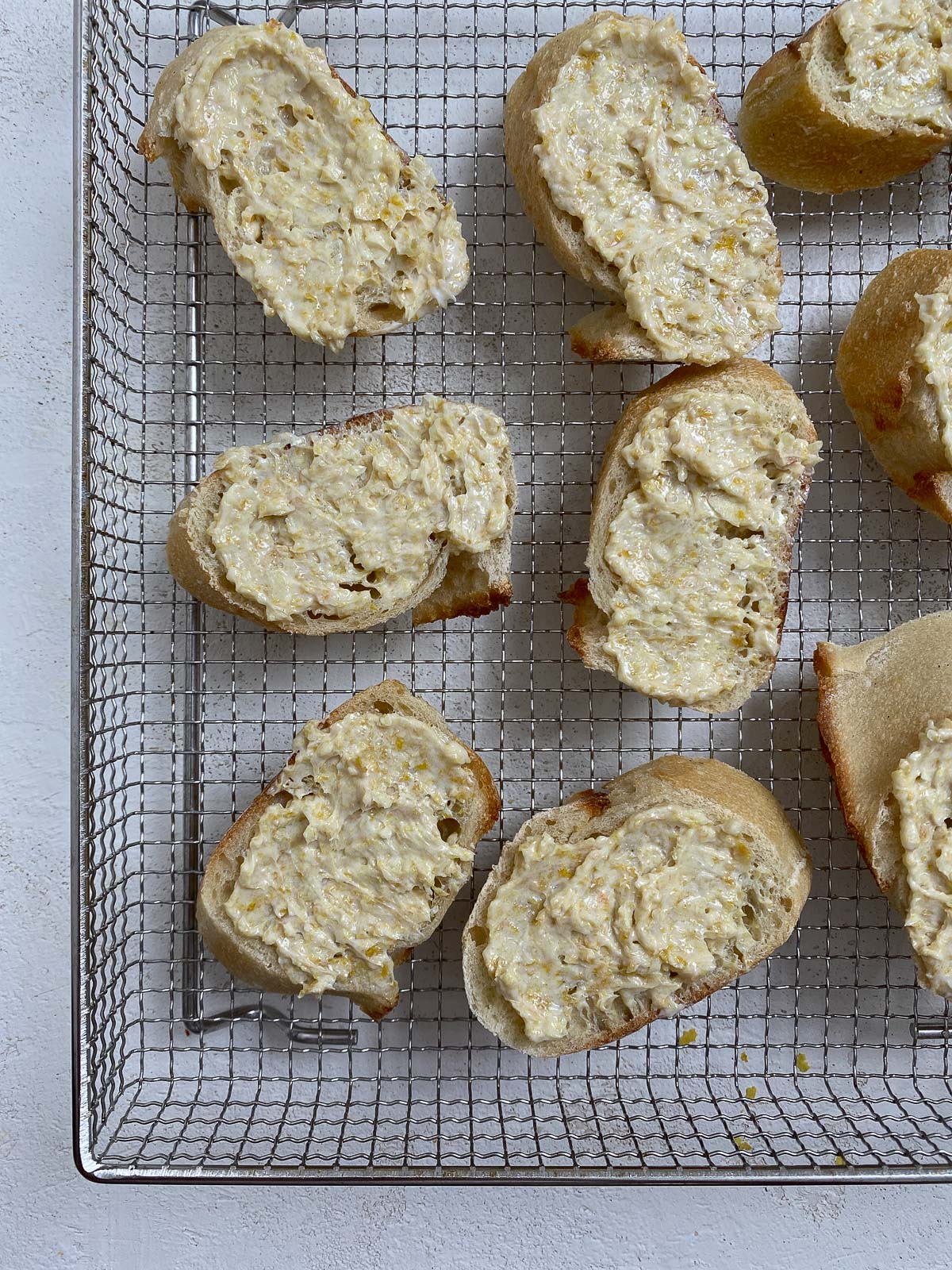 several pre air fried pieces of garlic bread on air fryer rack