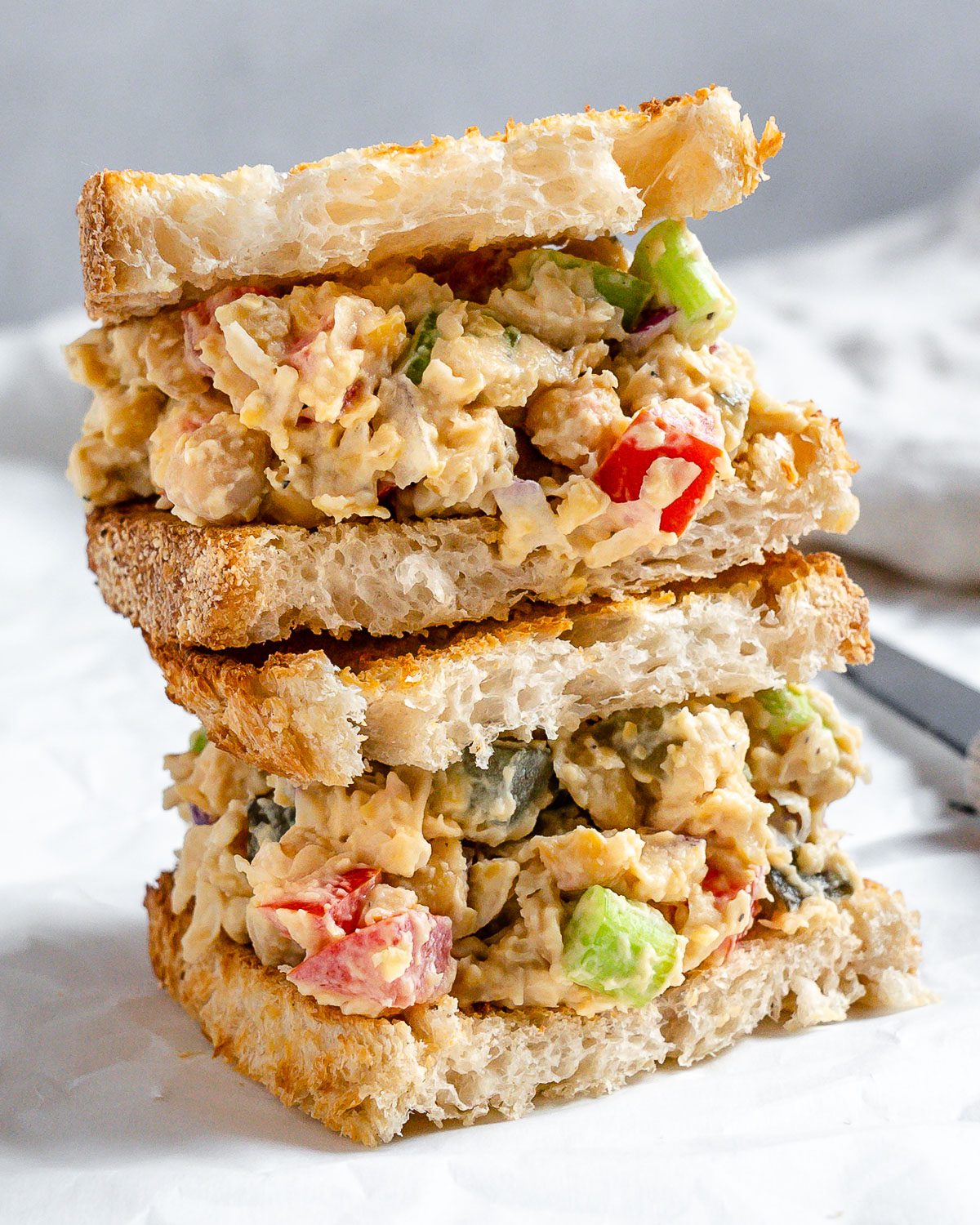 completed Vegan Chickpea Salad Sandwich on a white surface