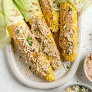 several completed Vegan Elote on a light dish against a light surface