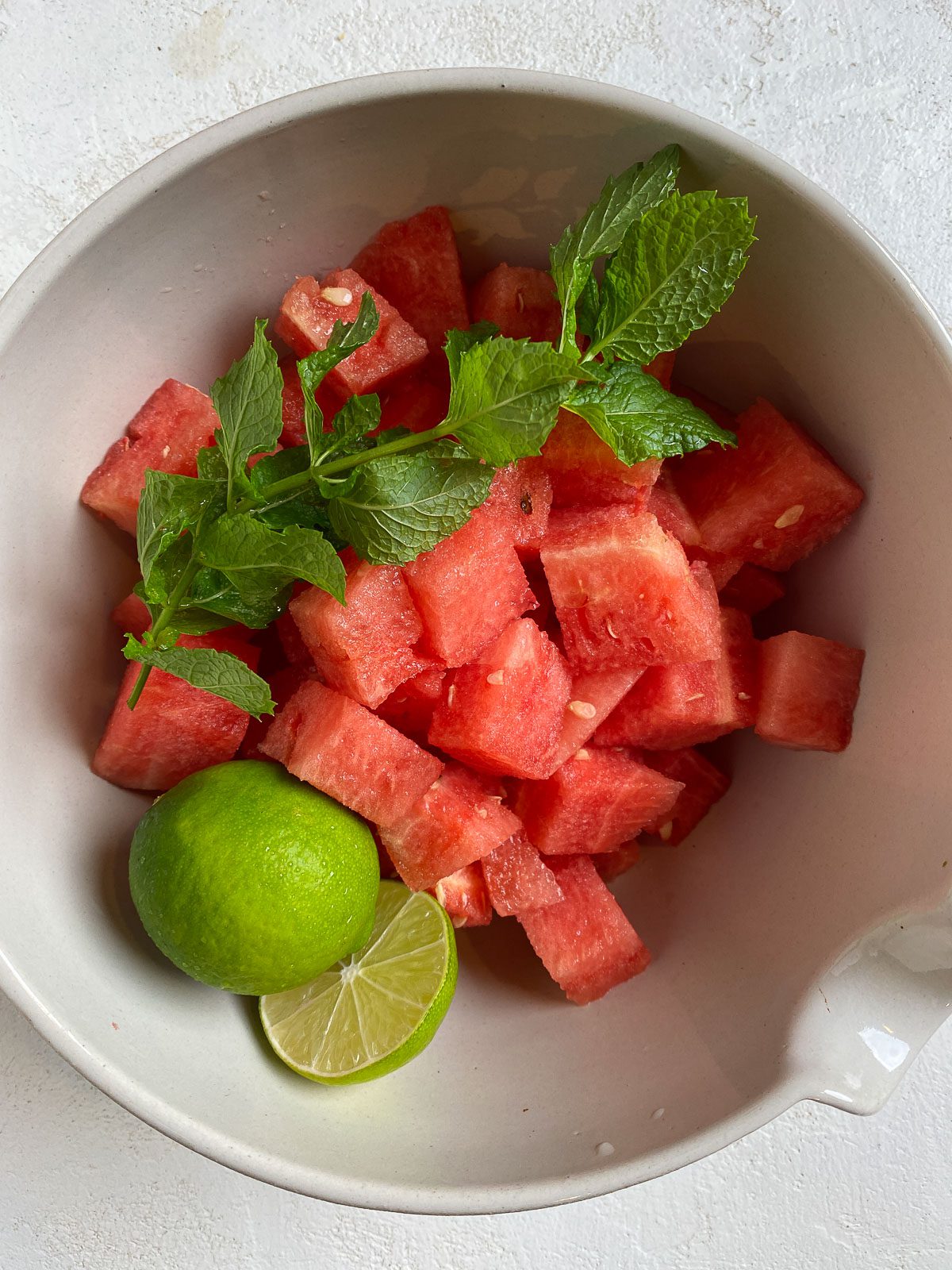 watermelon, mint, and lim in a bowl