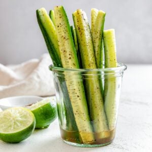 completed Cucumbers with Tajin in a clear glass against a light background