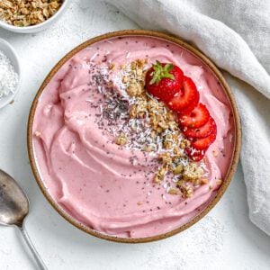 completed Strawberry Smoothie Bowl against a white surface
