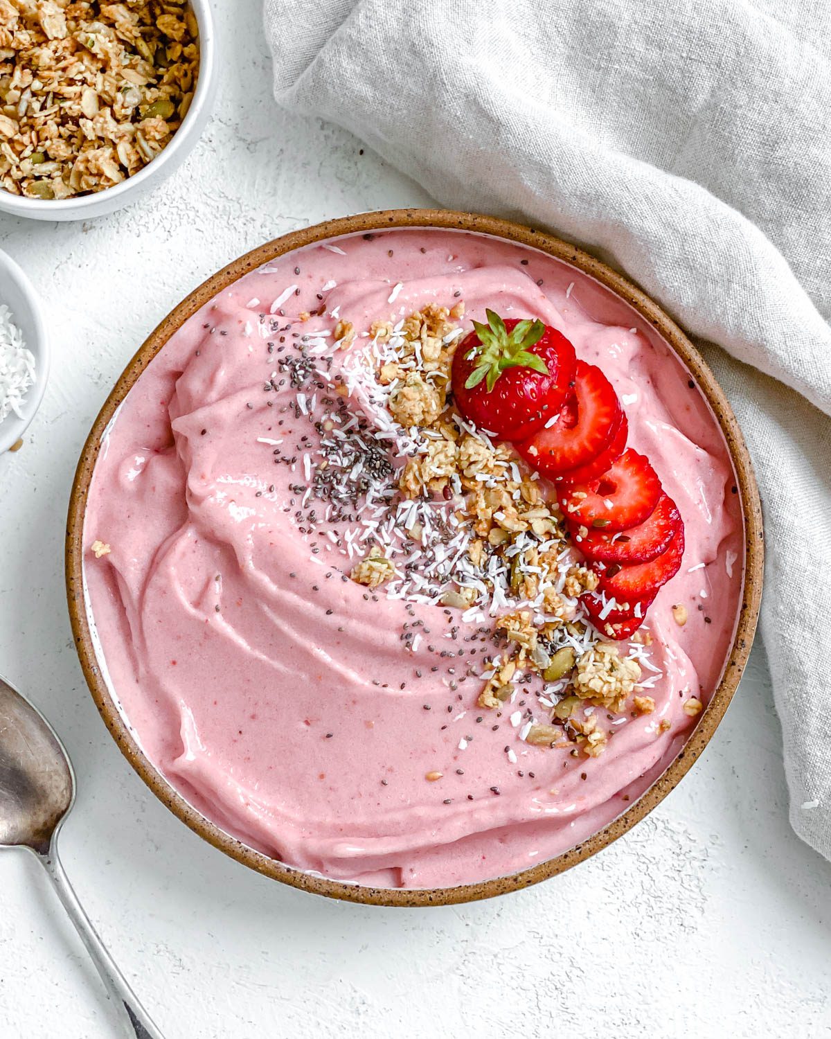 completed Strawberry Smoothie Bowl against a white surface
