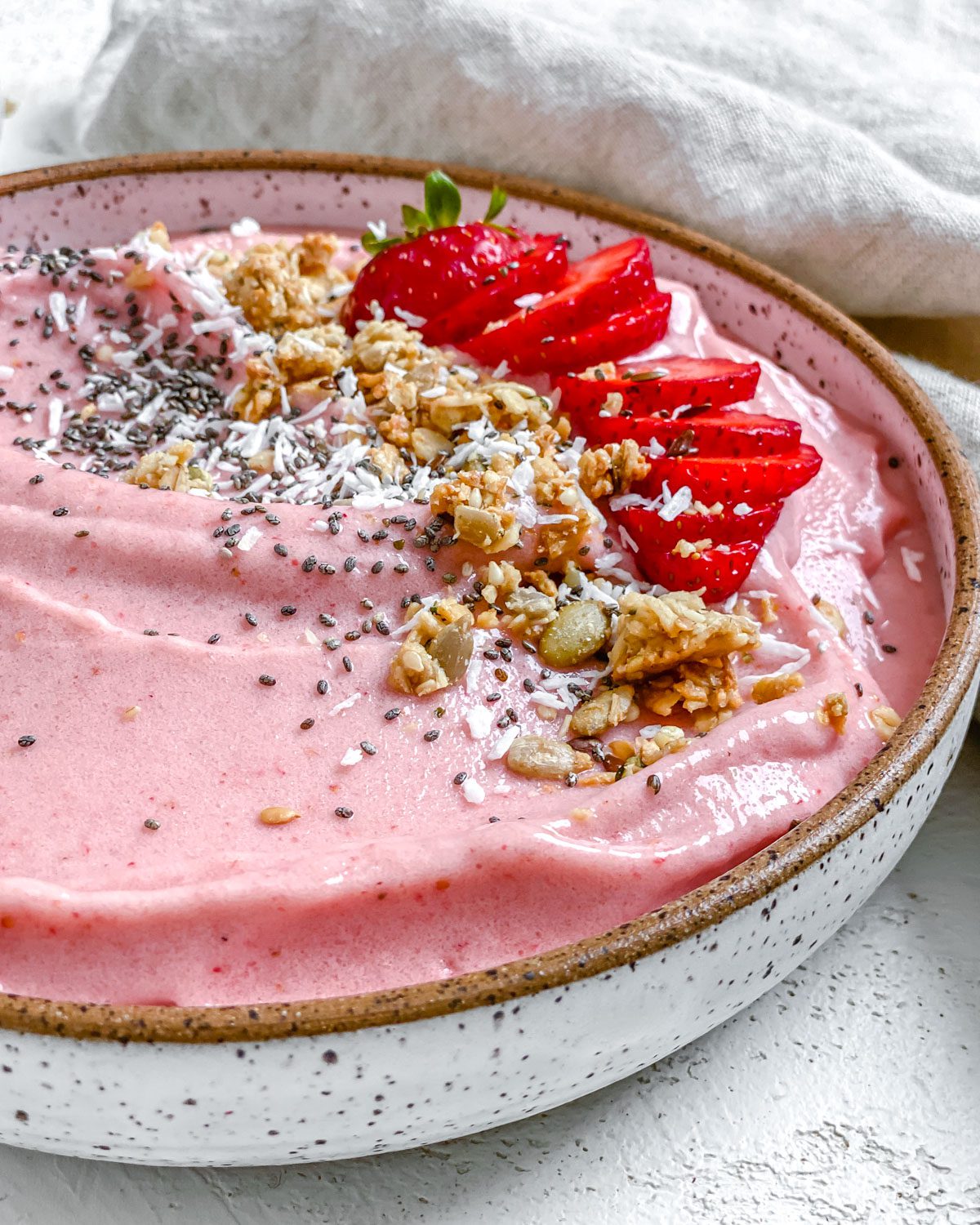 completed Strawberry Smoothie Bowl against a white surface