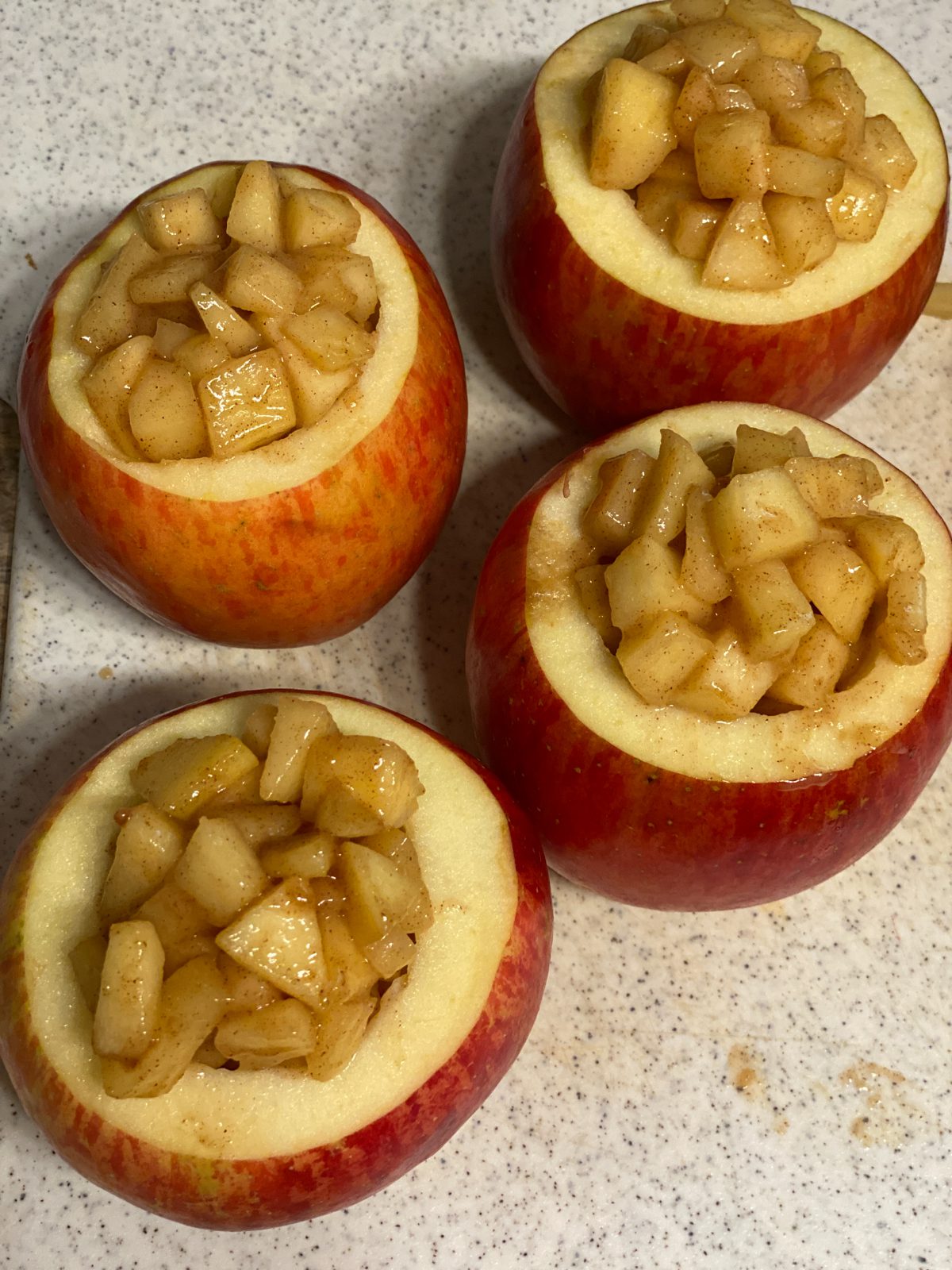Process shot showing four apple filled apples.