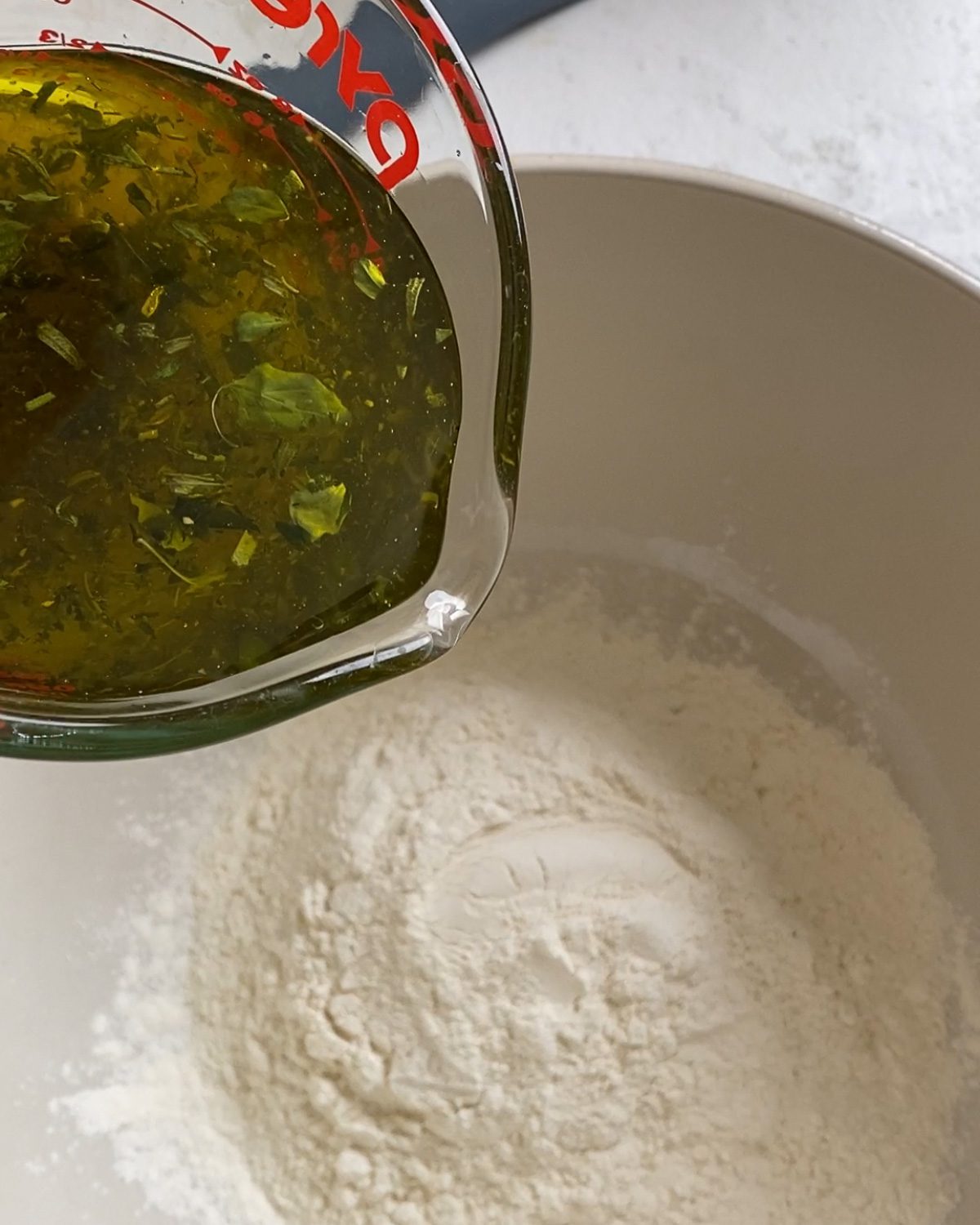 process of adding herb mixture to bowl