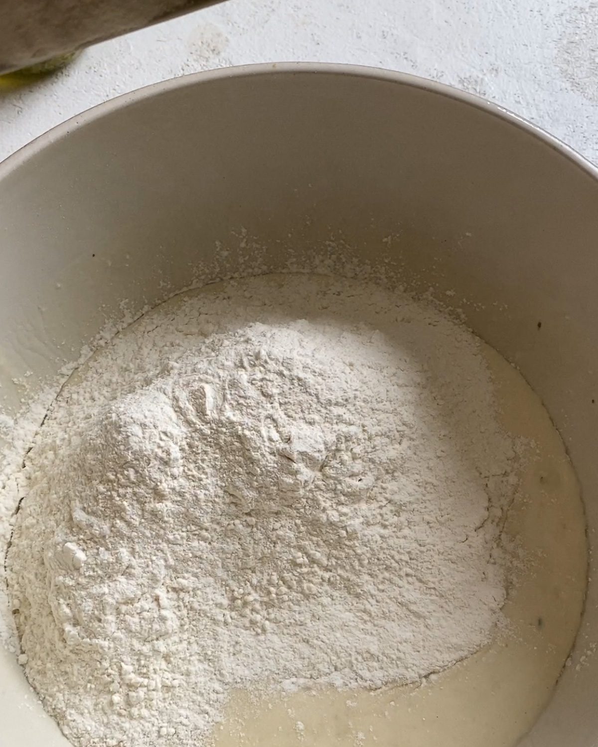 process of adding additional flour to mixture