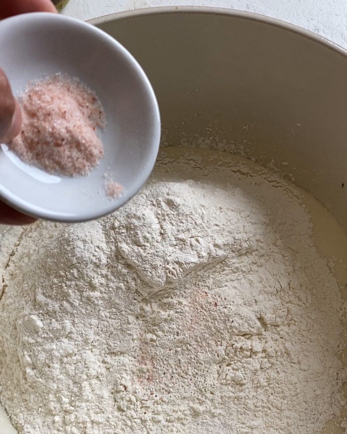 process of adding additional sauce to bowl