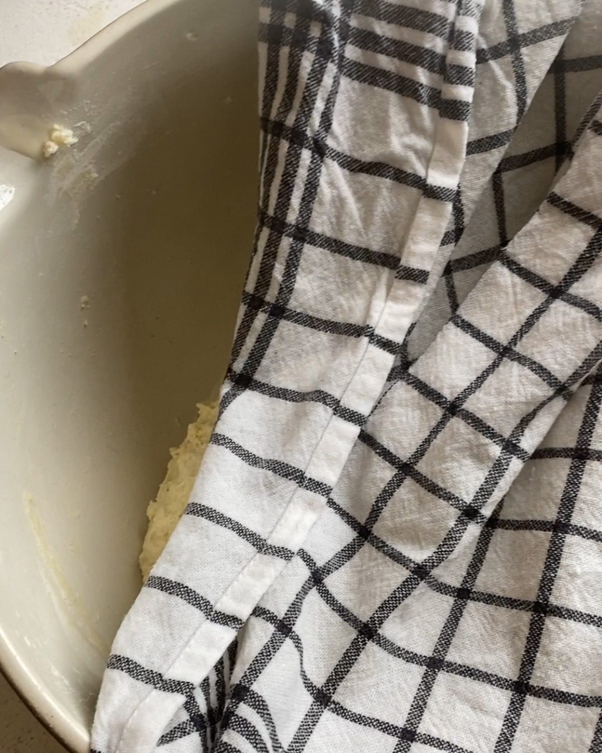 process of covering dough with damp towel