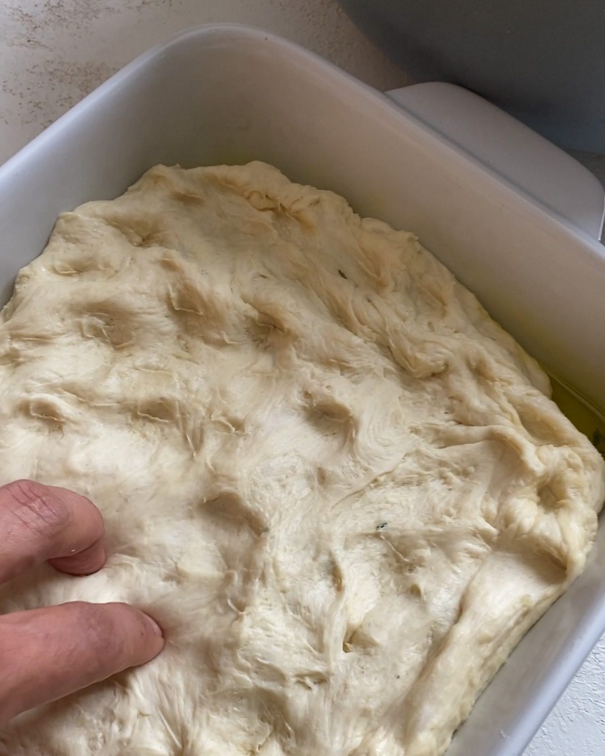 process shot of poking holes in dough in baking pan