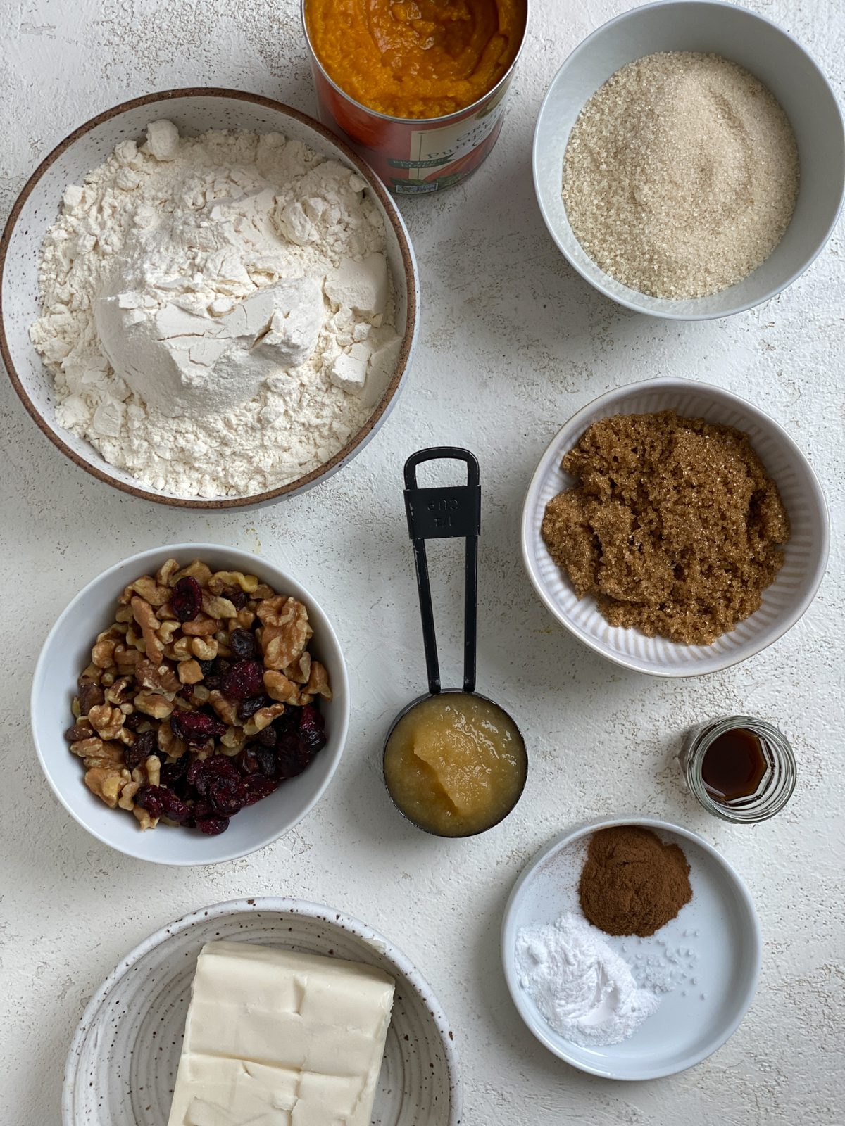 ingredients for Soft Gluten-Free Pumpkin Cookies measured out against a white surface