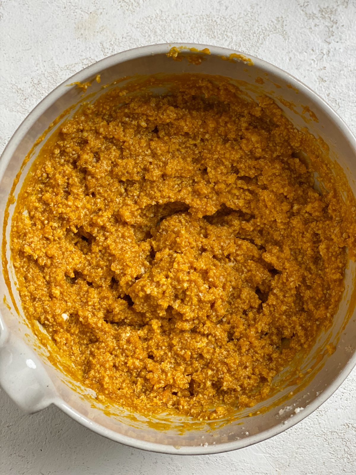 process shot post Soft Gluten-Free Pumpkin Cookies dough being mixed in bowl
