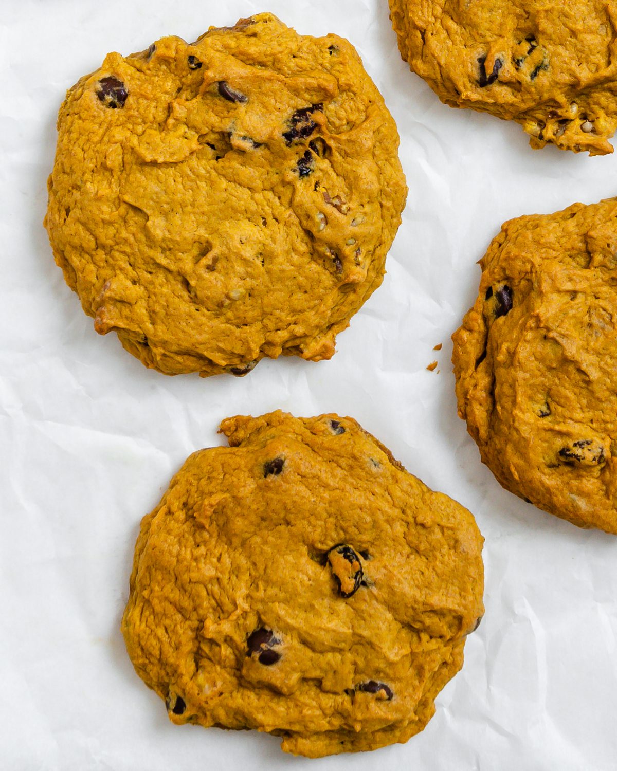 completed Soft Gluten-Free Pumpkin Cookies scattered on a white surface