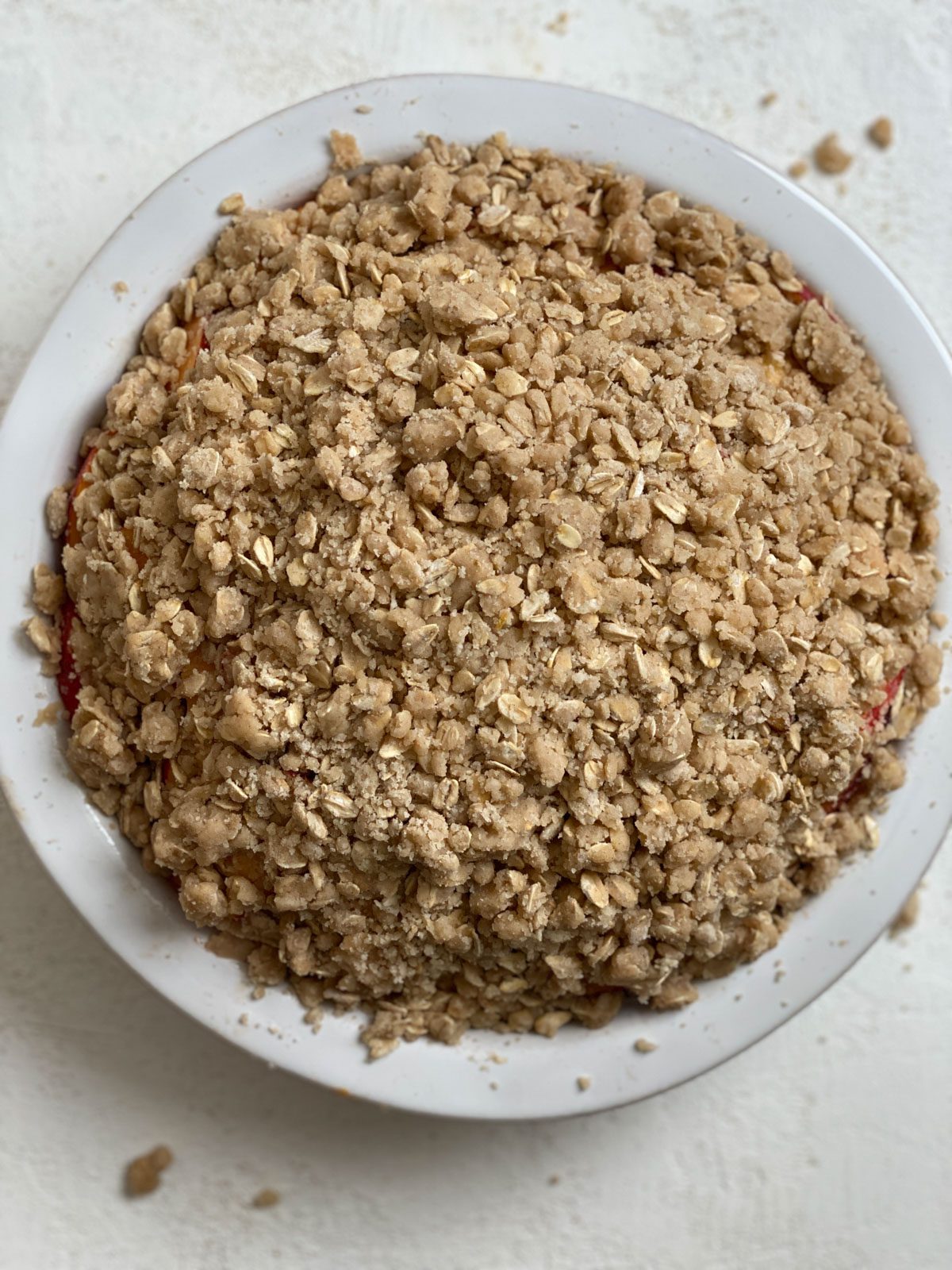 pre baked Vegan Peach Crisp in a pie pan