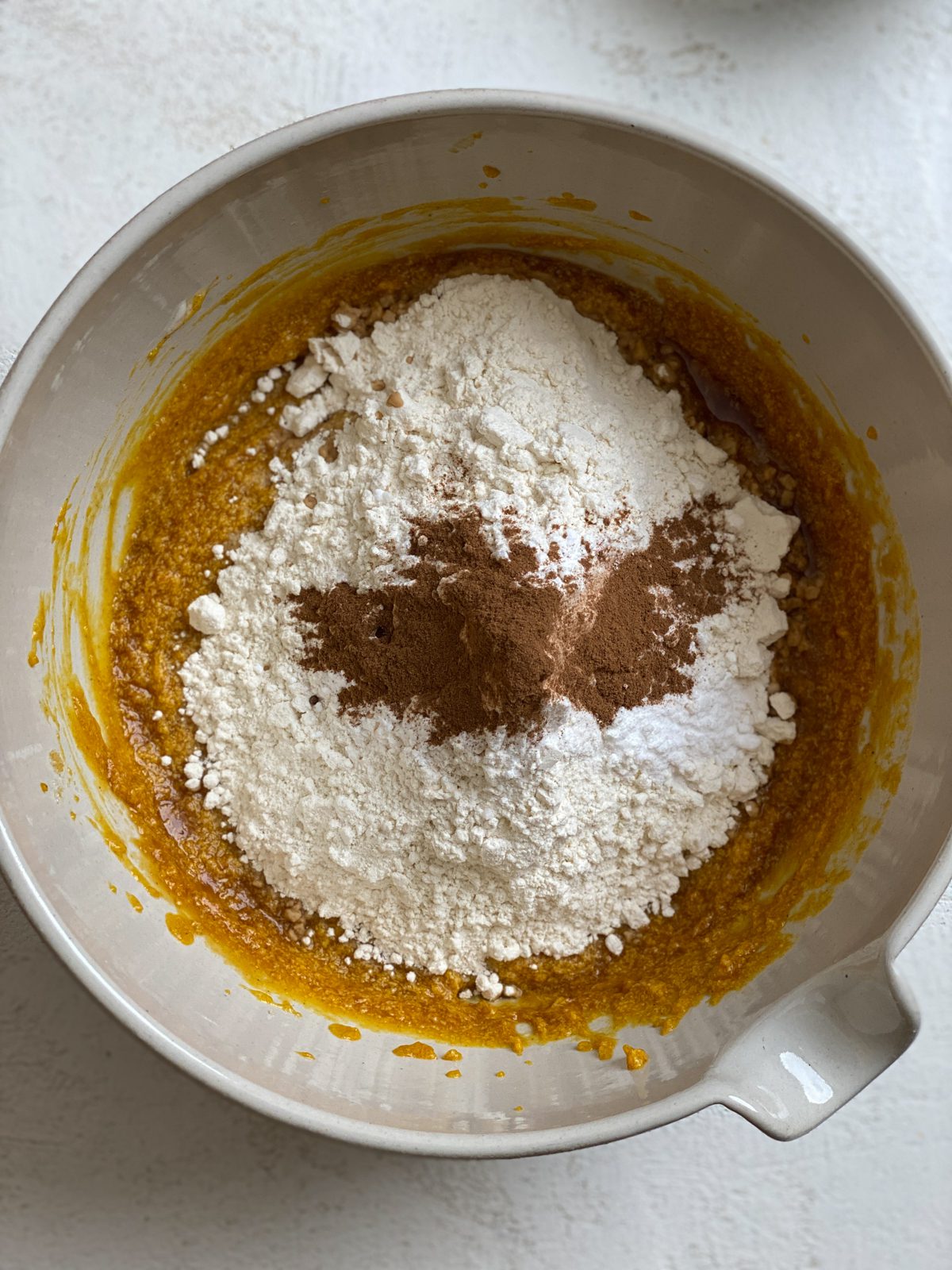 process shot of ingredients for Easy Vegan Pumpkin Muffins added to a bowl