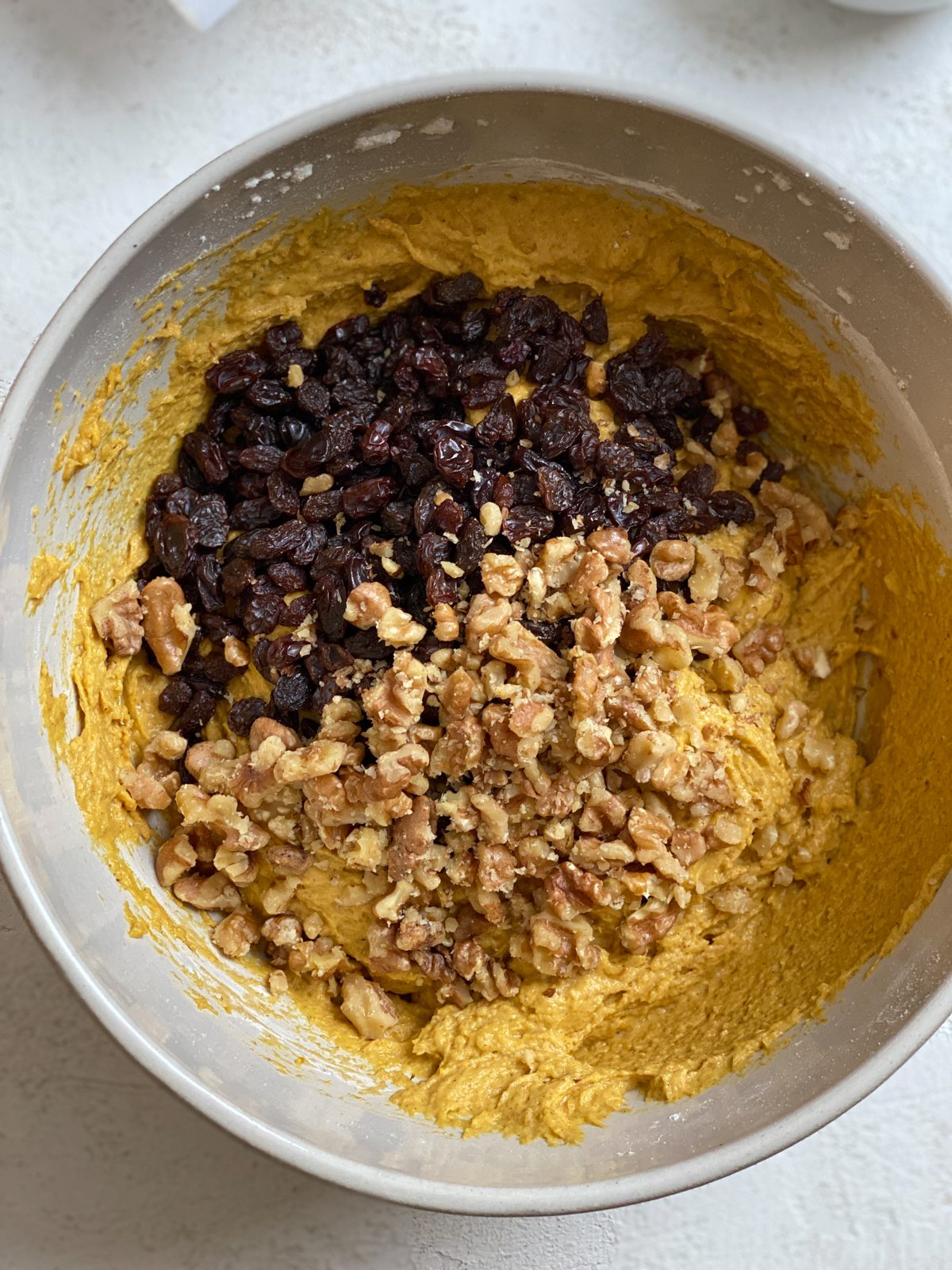 process shot of ingredients for Easy Vegan Pumpkin Muffins added to a bowl