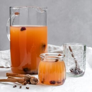 completed Vegan Instant Pot Apple Cider in two glass containers on a white surface