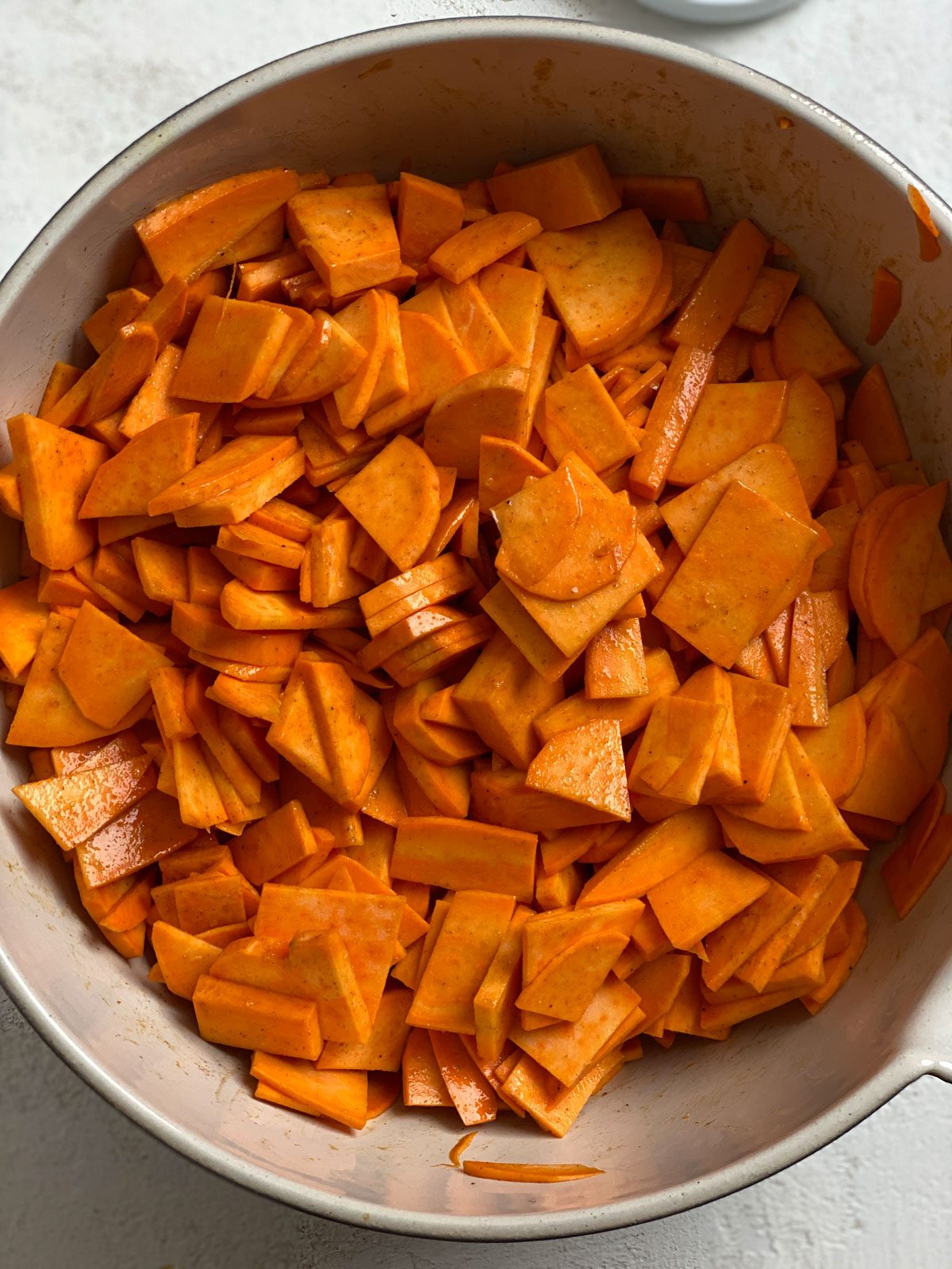 process shot of mixing candied mixture in yams in a bowl
