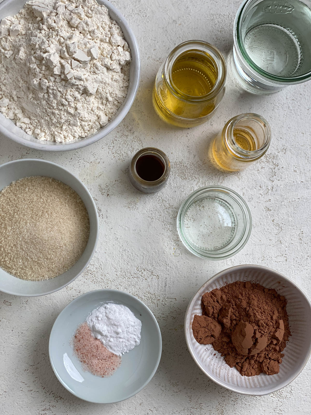 ingredients for Easy Vegan Chocolate Cupcakes measured out against white background