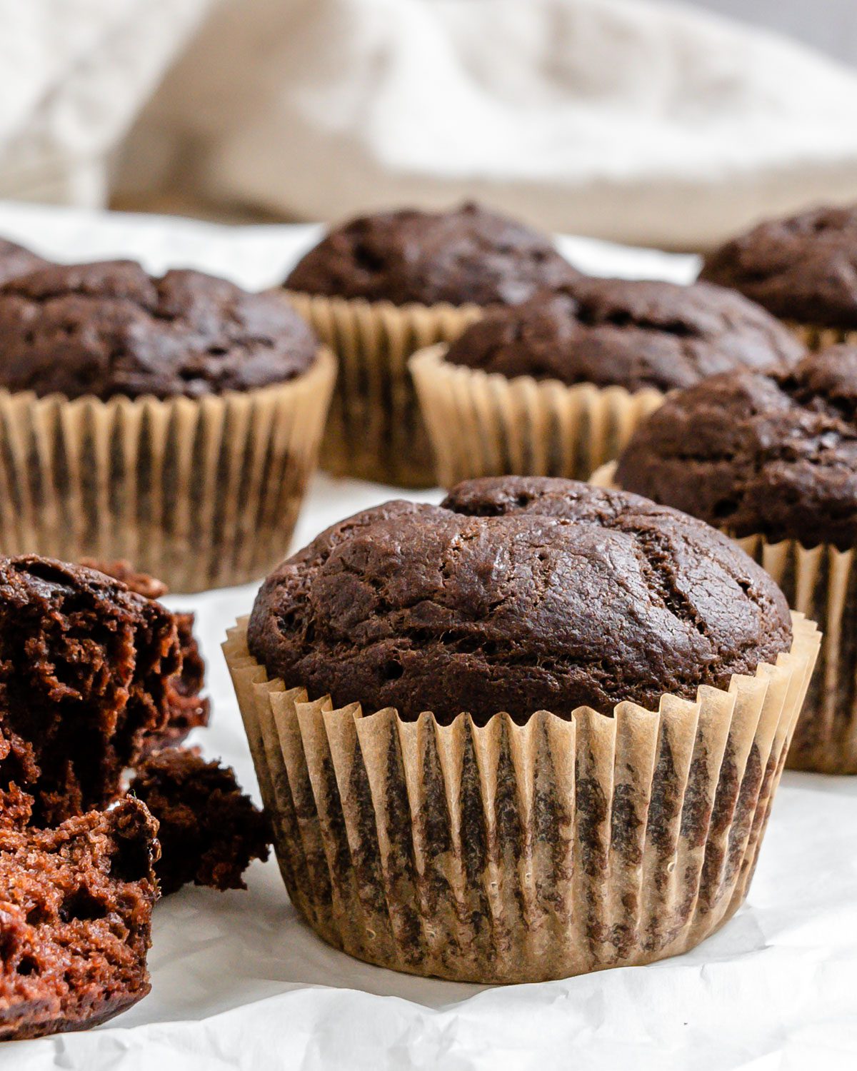 completed Vegan Chocolate Cupcakes scattered on a white surface