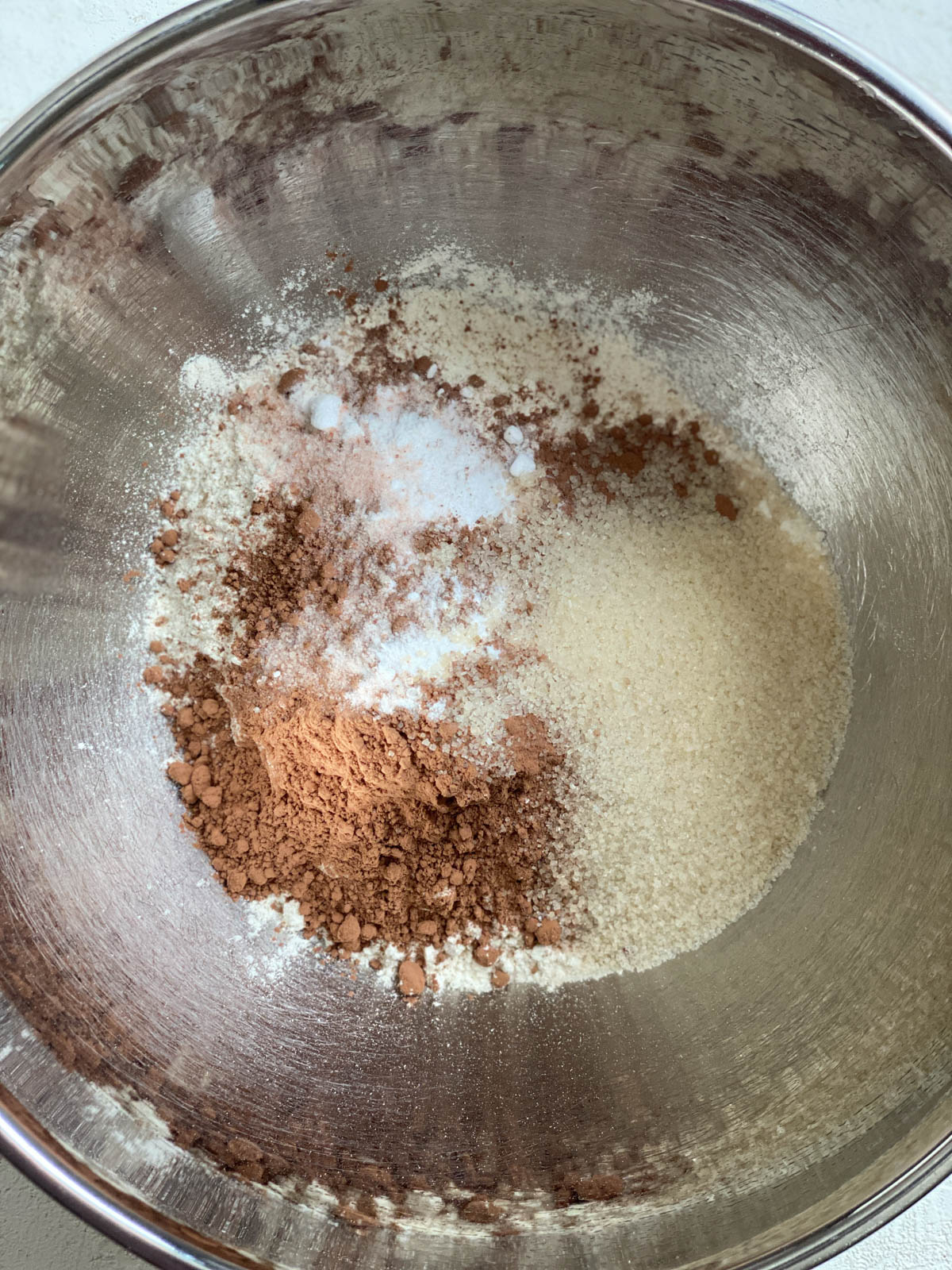 process shot of ingredients added to a bowl for Easy Vegan Chocolate Cupcakes