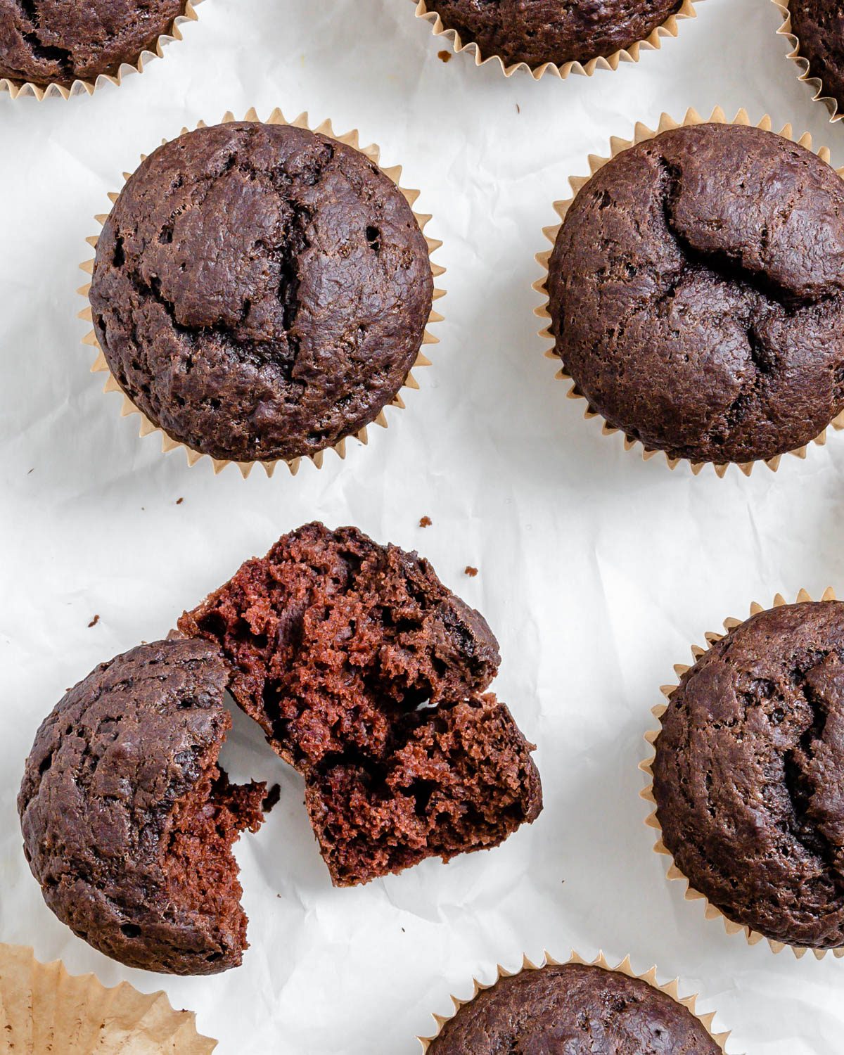 completed Vegan Chocolate Cupcakes scattered on a white surface