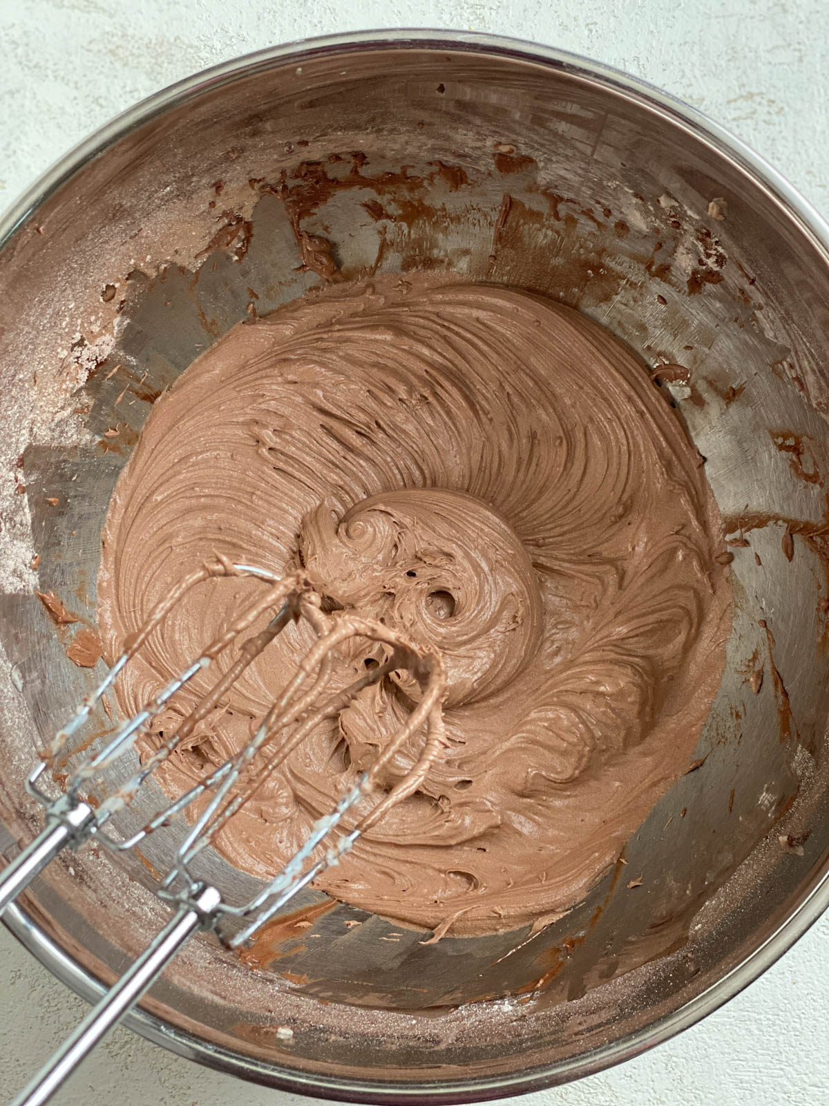process shot post whipping ingredients for Vegan Chocolate Frosting in bowl