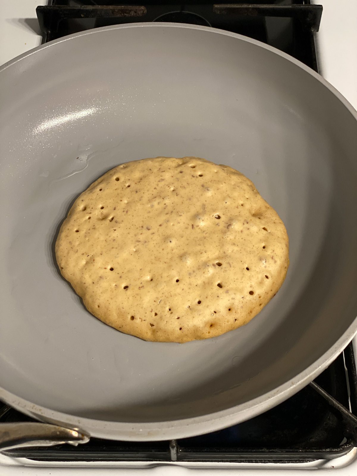 process shot of cooking individual Vegan Pumpkin Pancake on skillet