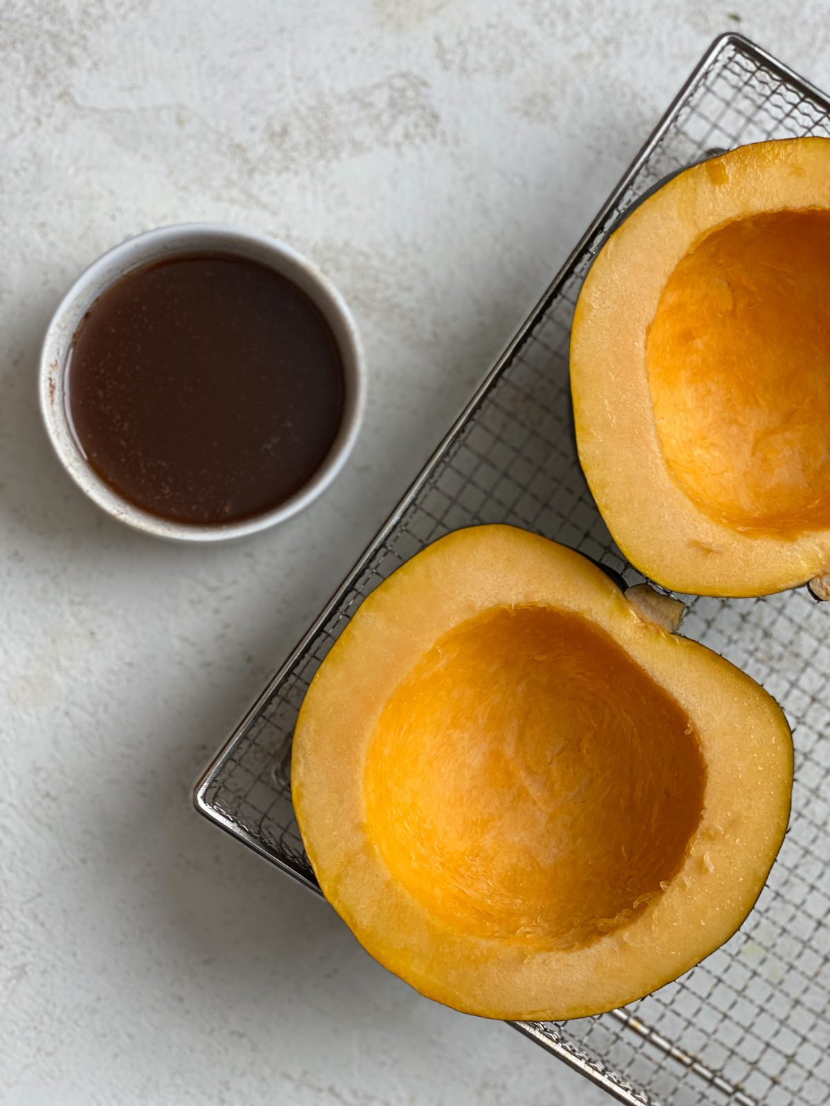 pre air fried butternut squash alongside butter mixture against white surface
