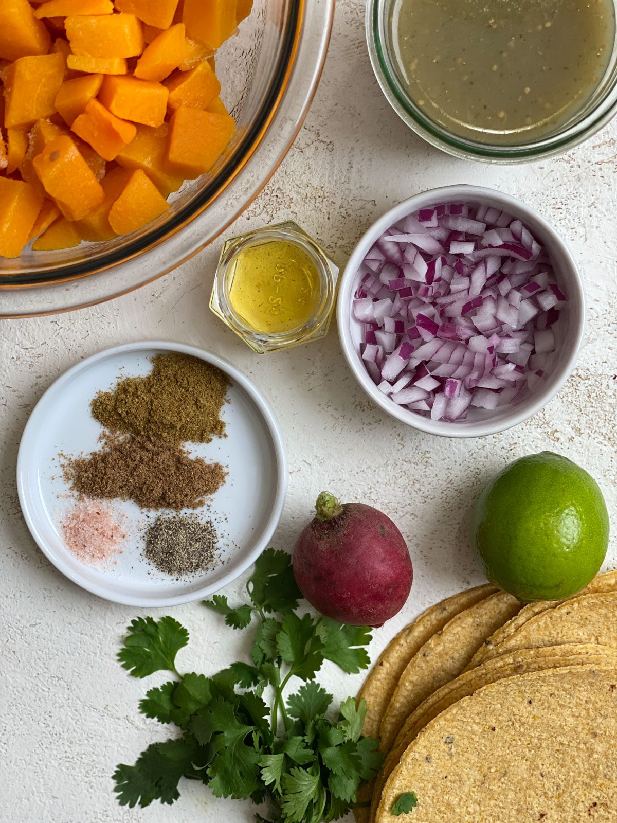 ingredients for Easy Butternut Squash Enchiladas measured out against white background