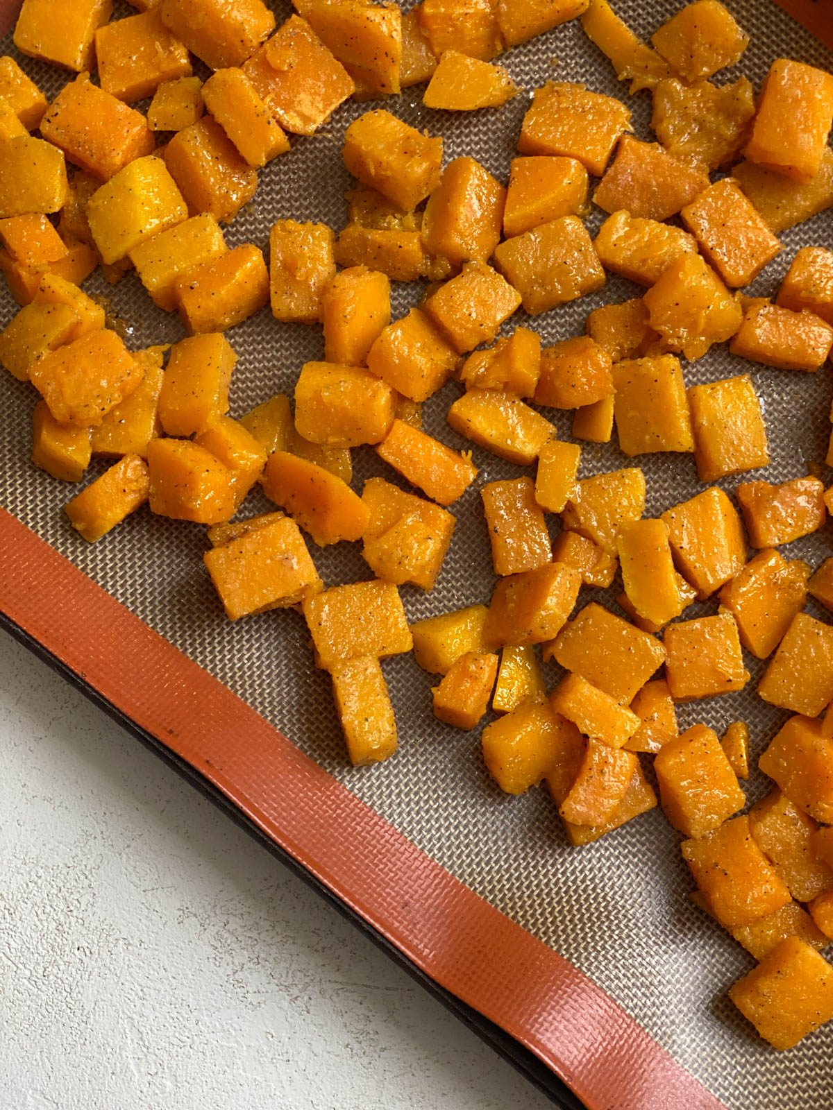 cubed butternut squash on a baking tray