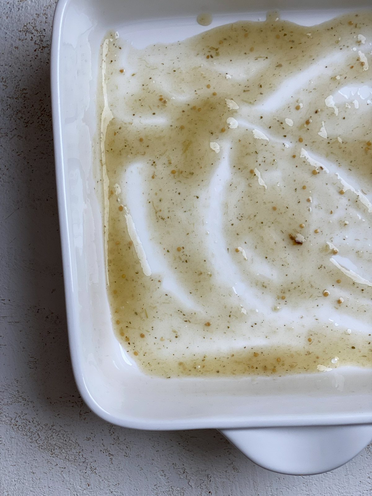 process shot of spreading sauce on bottom of baking tray