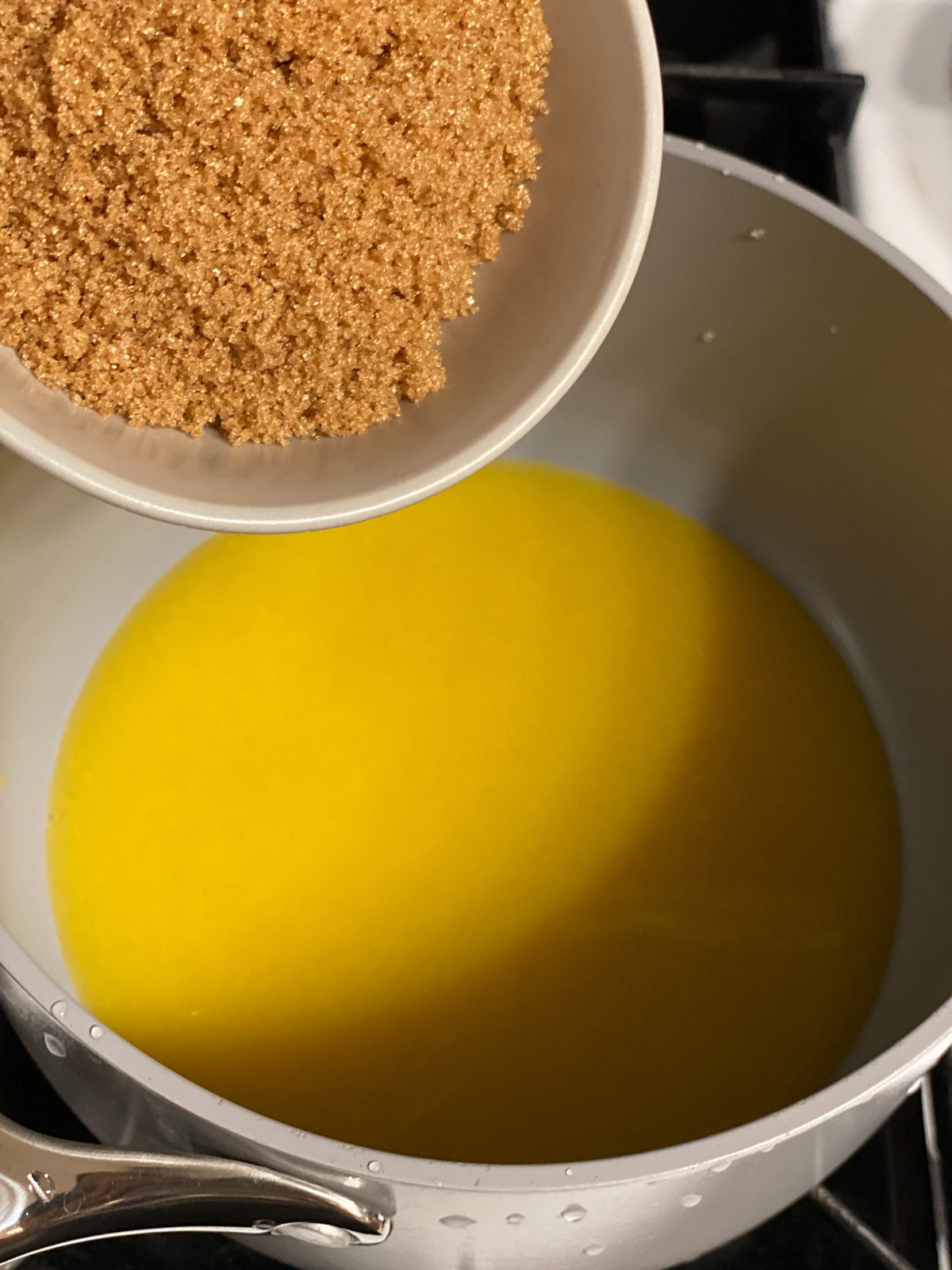 process shot of adding brown sugar to pan
