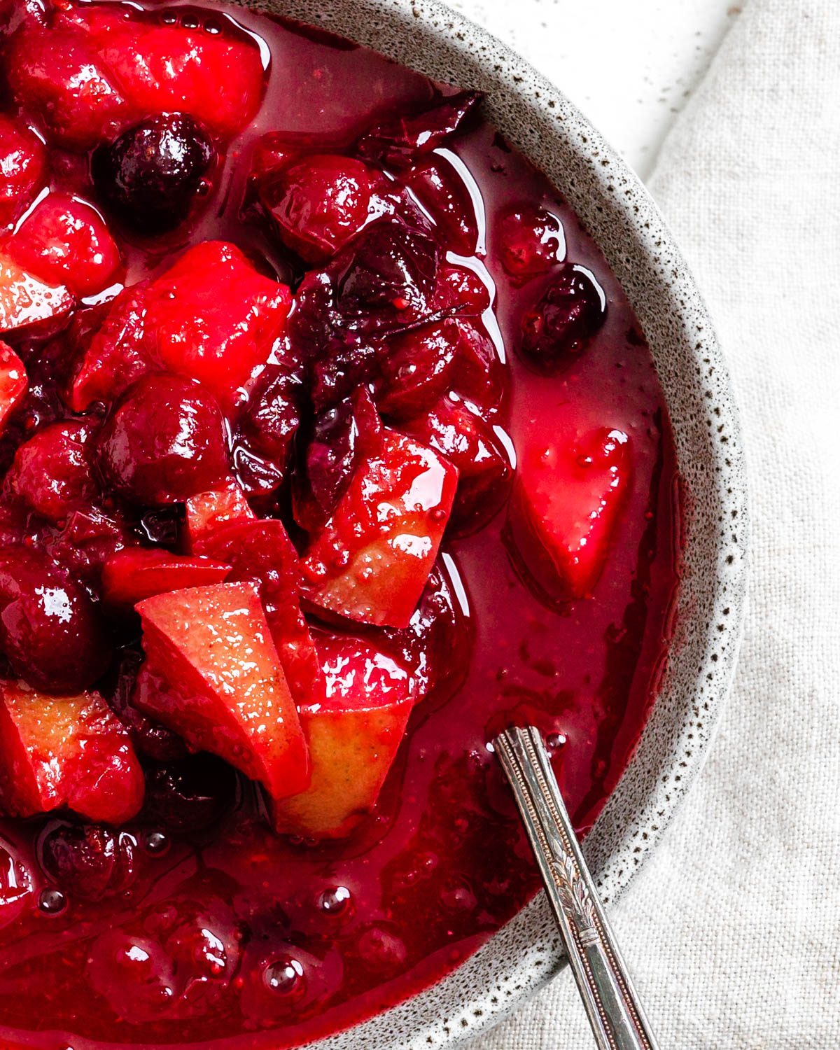completed Easy Cranberry Pear Sauce in a bowl against a white surface