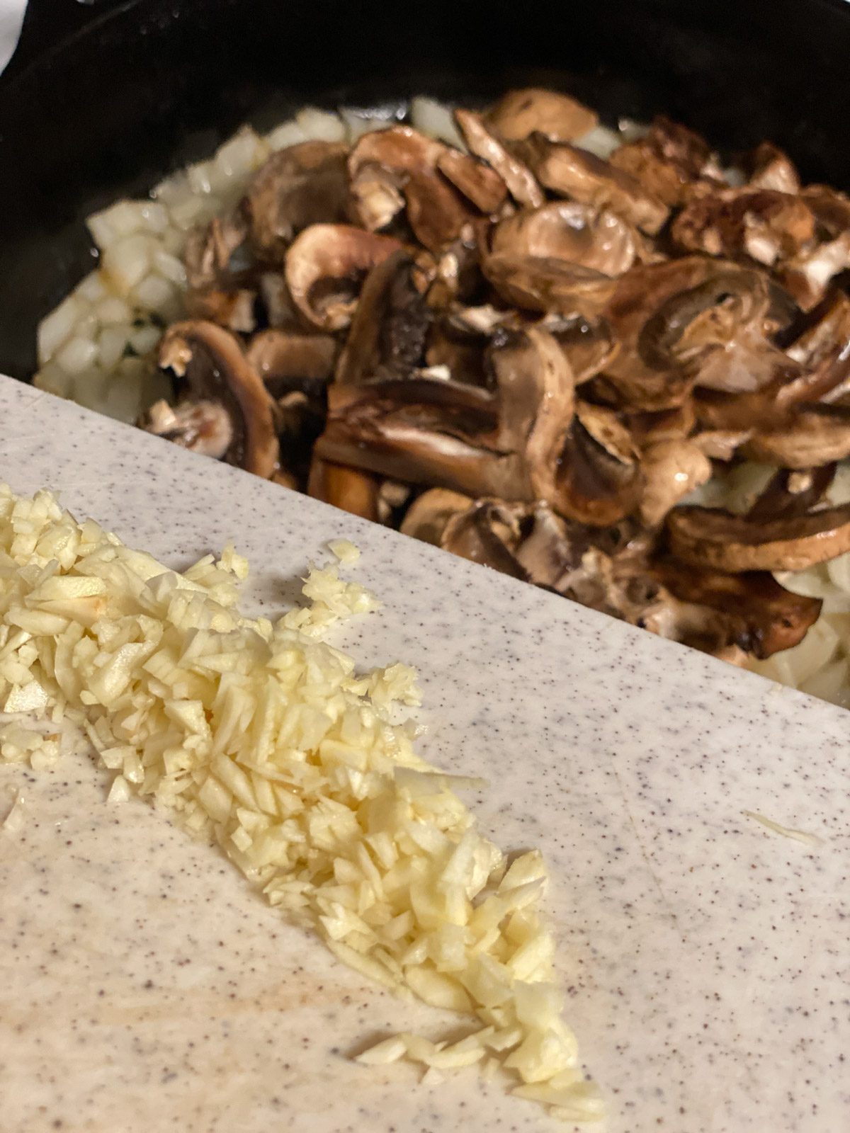 process shot of adding garlic to pan