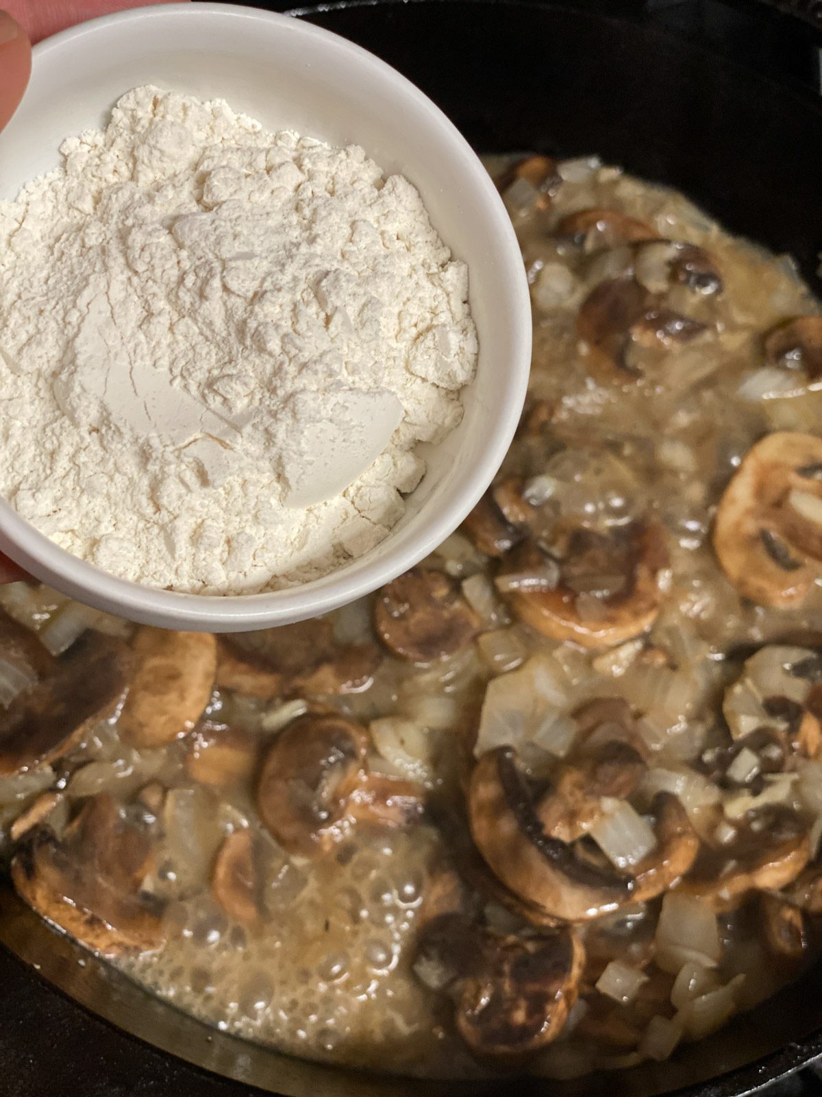 process shot of adding flour to pan