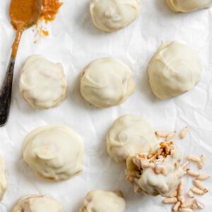 completed Peanut Butter Balls with Rice Krispies scattered on a white surface