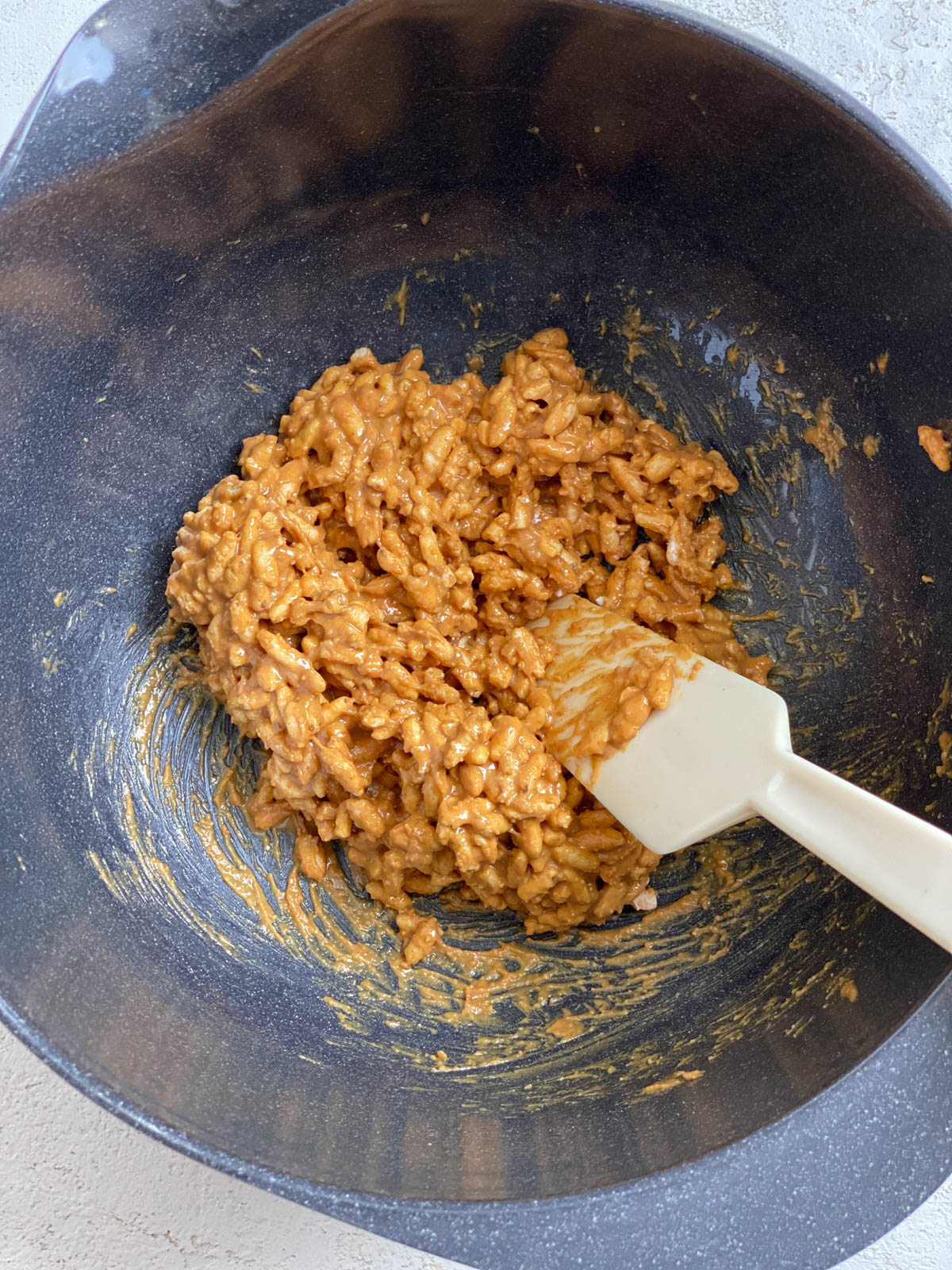 process shot of mixing ingredients in a bowl with utensil