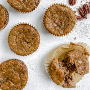 completed Vegan Cinnamon and Banana Pecan Muffins scattered on a white surface