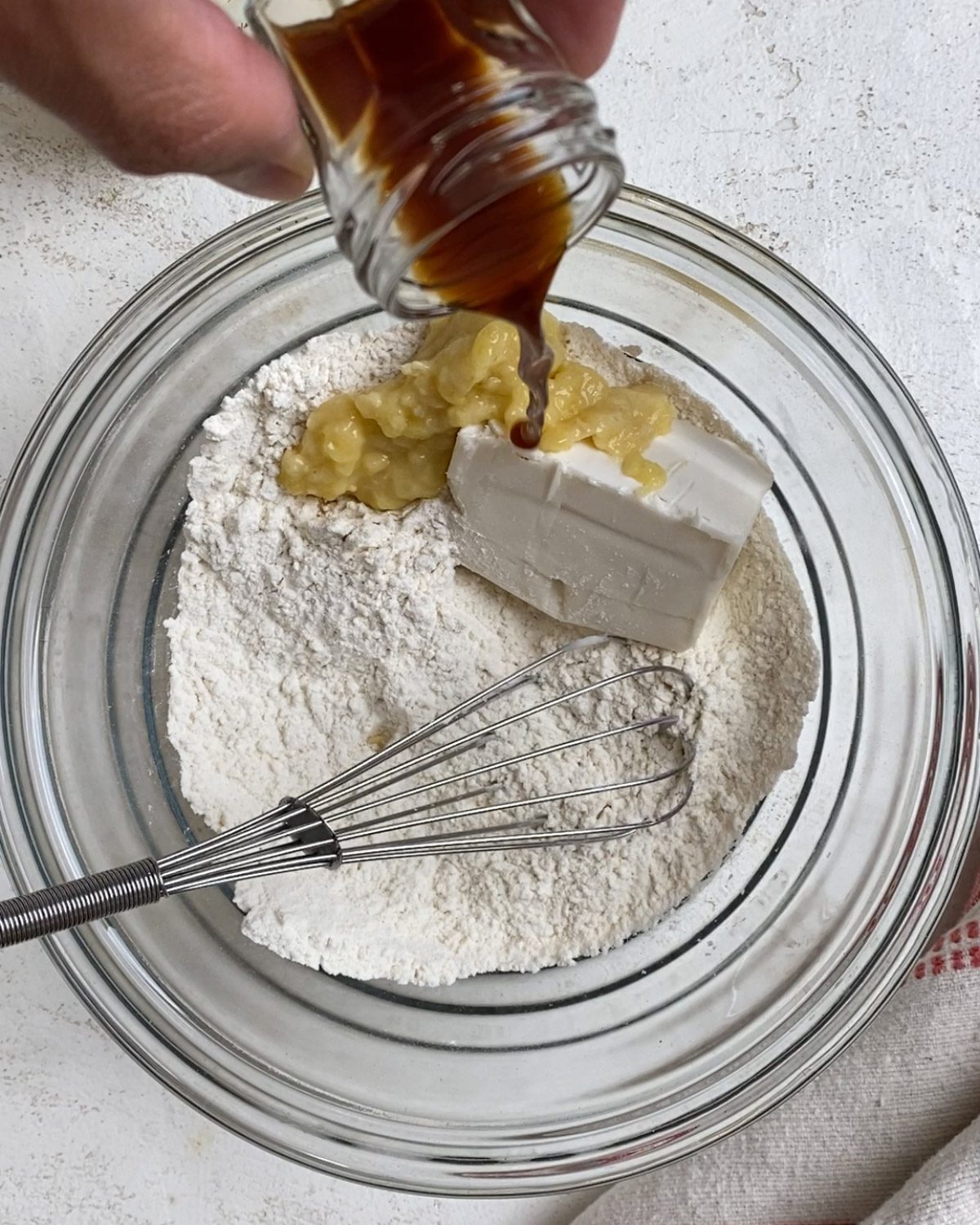 process of adding vanilla to bowl