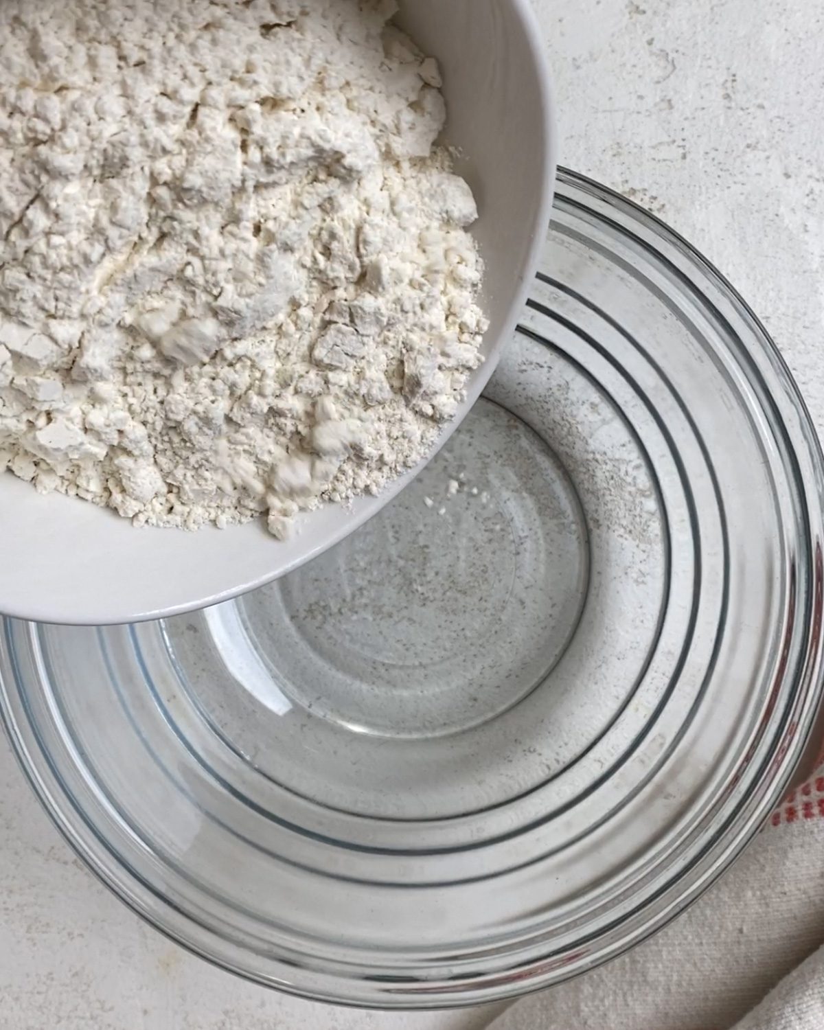 process of adding flour to bowl
