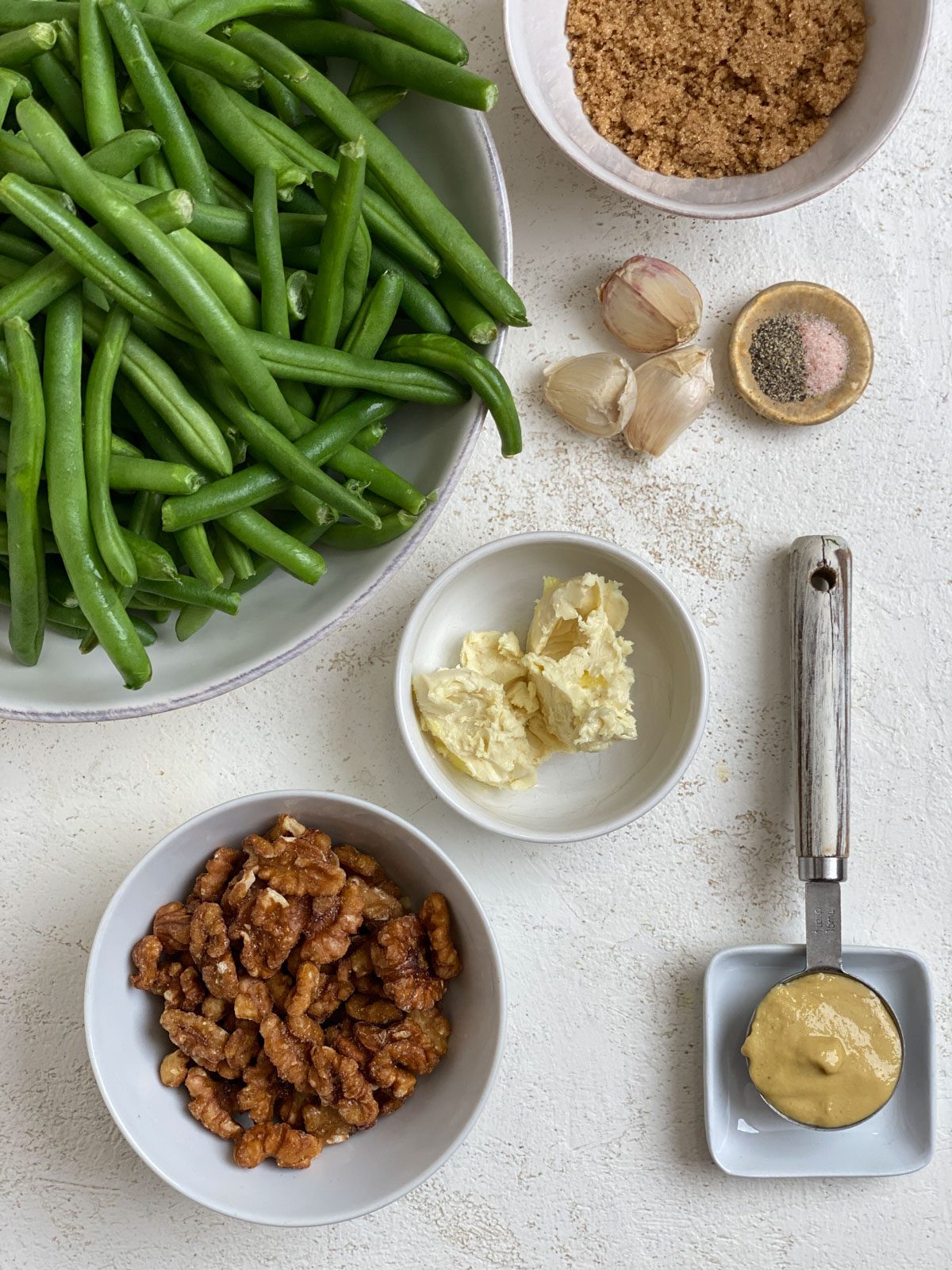 Ingredients for Brown Sugar Green Beans [No Bacon] measured out against a white surface.