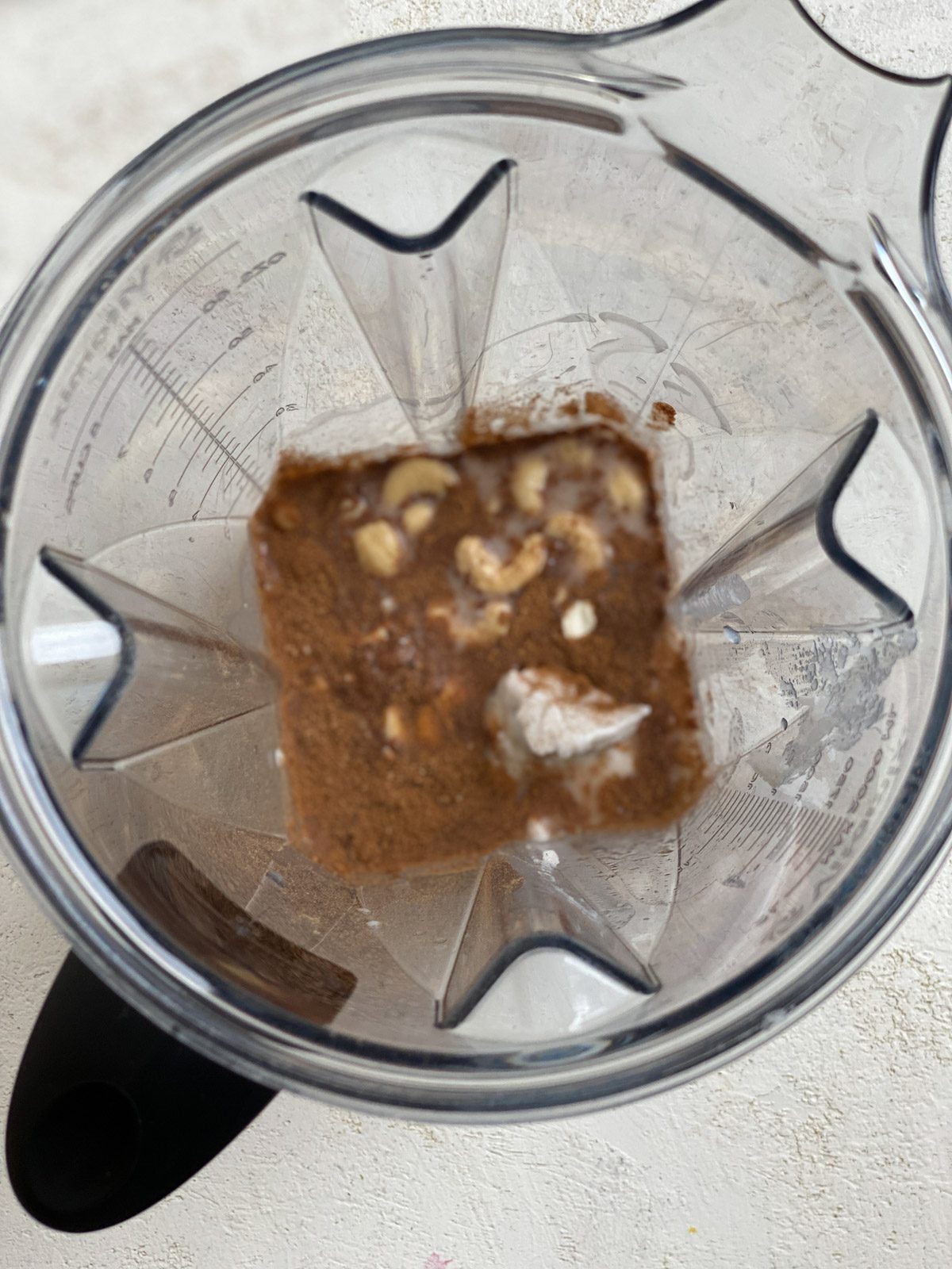 process of adding ingredients for eggnog in a blender
