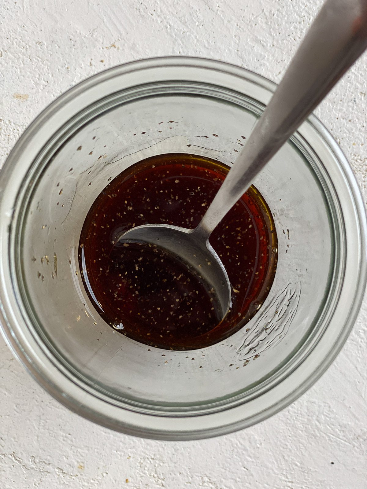 process of mixing dressing ingredients in a glass jar