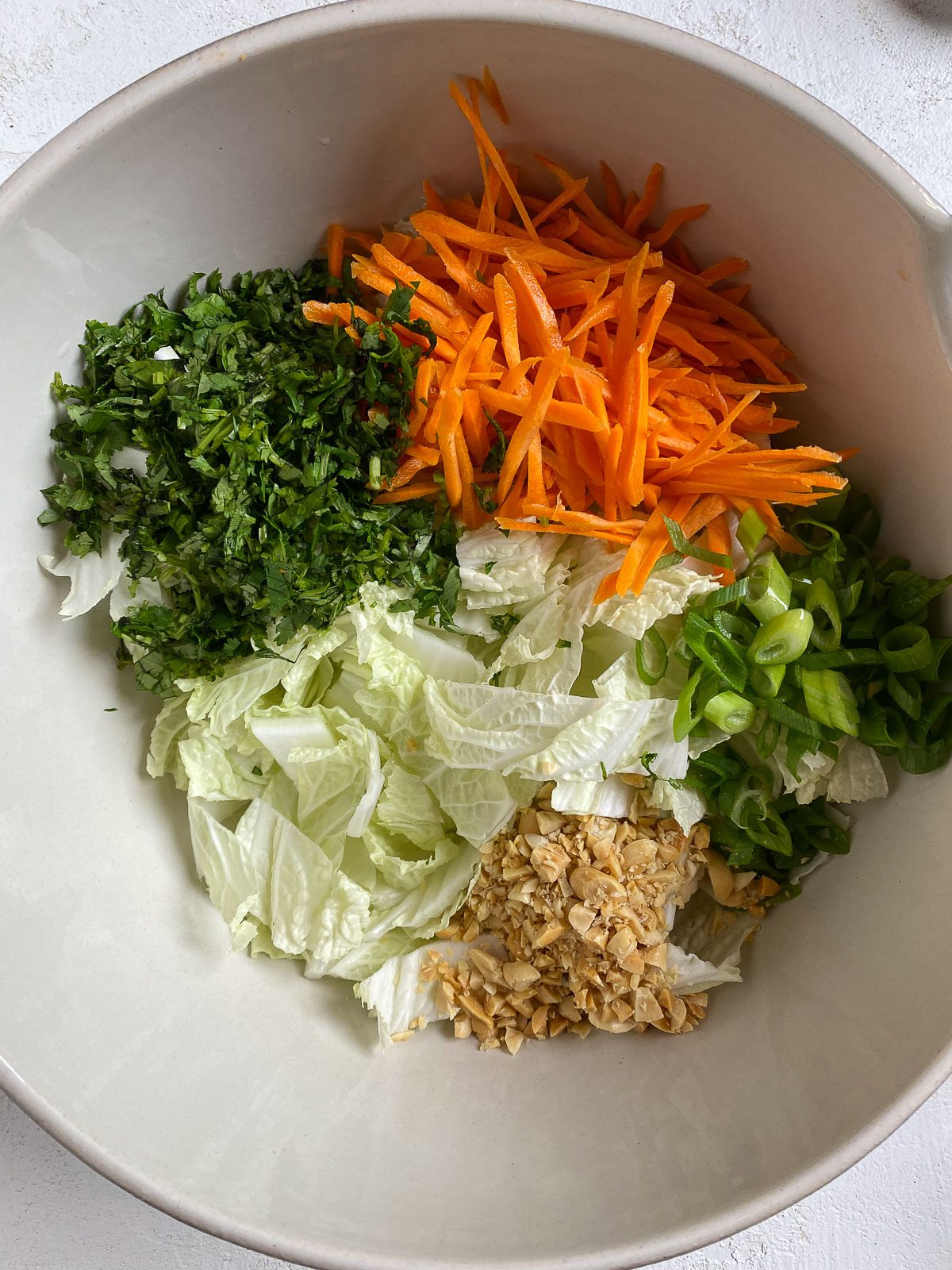 process shot of veggie ingredients added to bowl